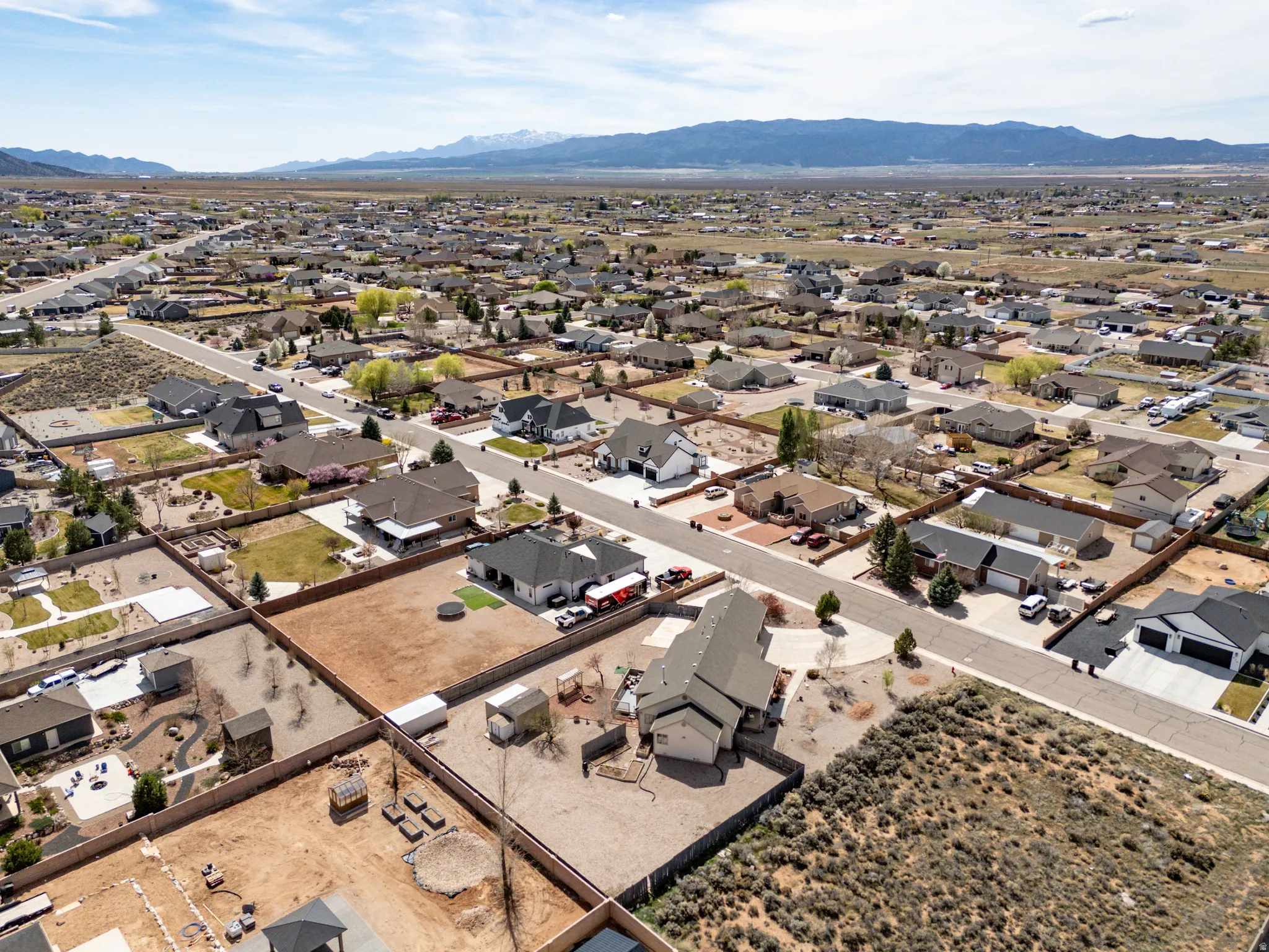 Aerial perspective of suburban area featuring a mountain backdrop
