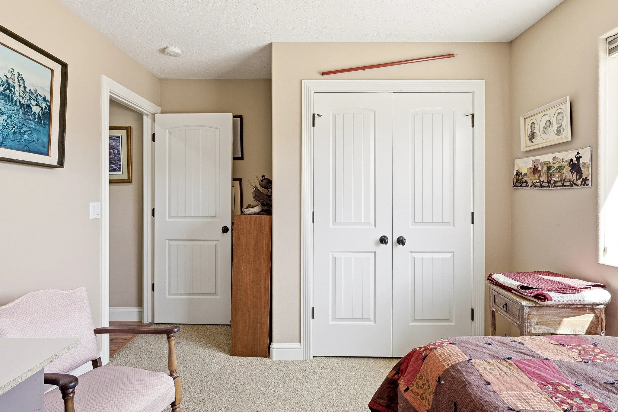 Bedroom featuring a closet, light colored carpet, and a textured ceiling