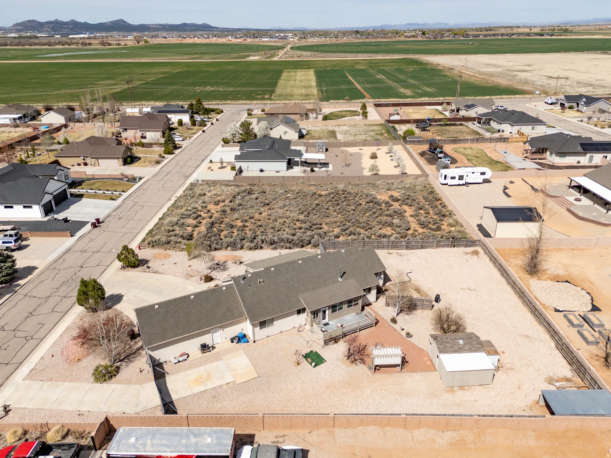 Aerial view of property and surrounding area featuring nearby suburban area