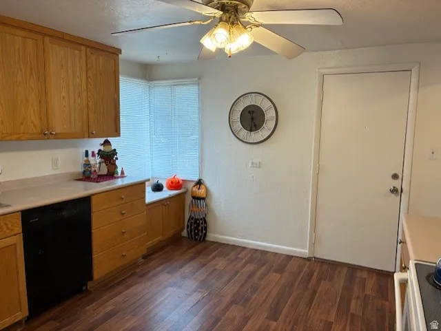 Kitchen with light countertops, black dishwasher, ceiling fan, electric range oven, and dark wood-type flooring