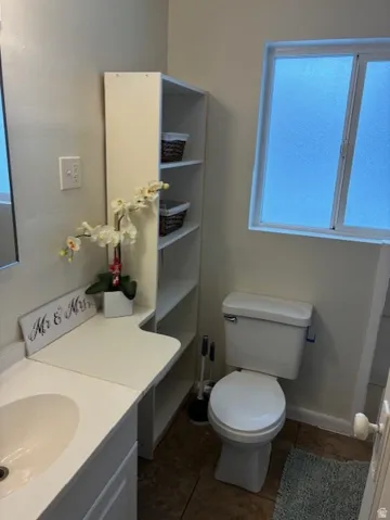 Bathroom featuring vanity and dark tile patterned floors