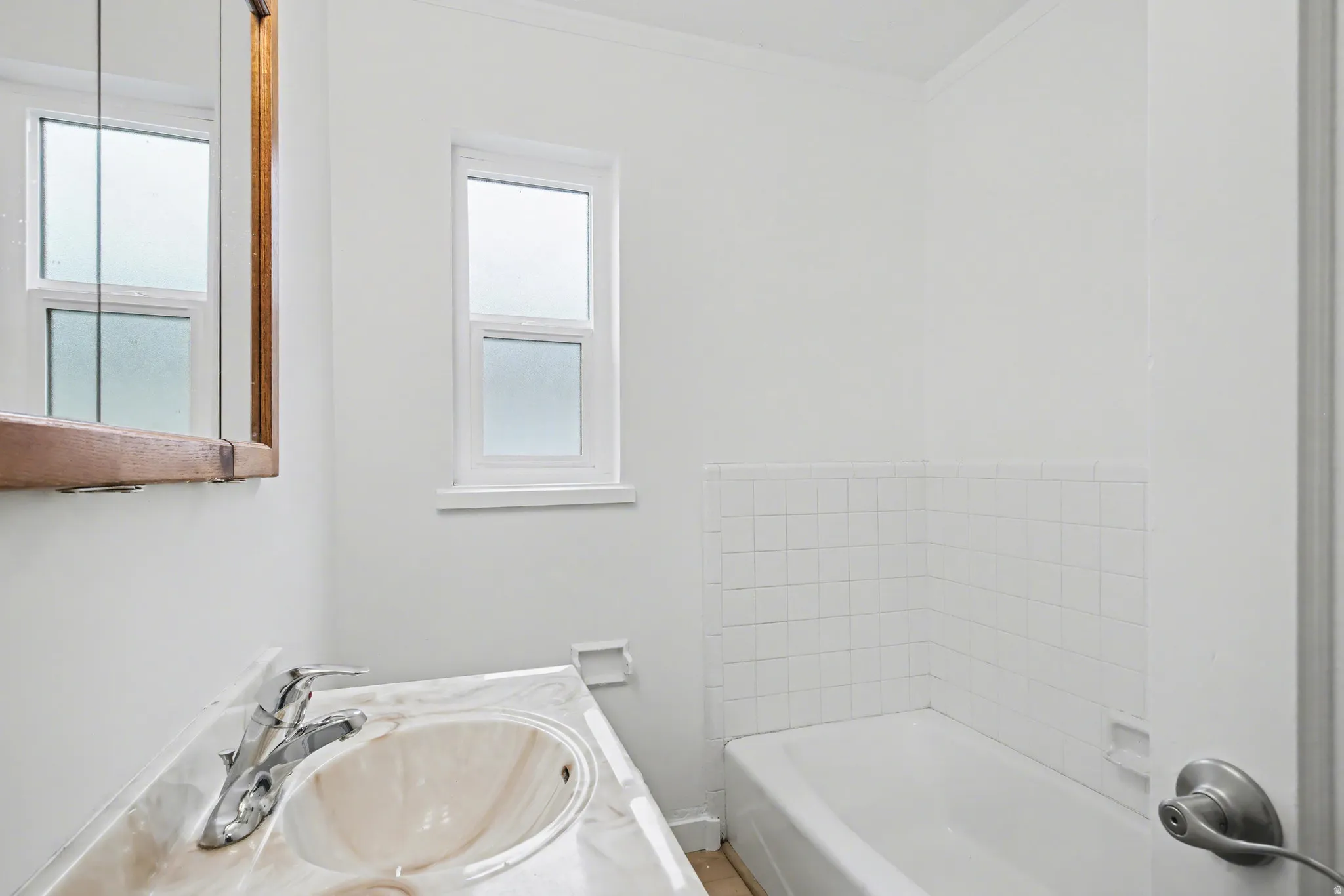 Full bath with vanity and a garden tub
