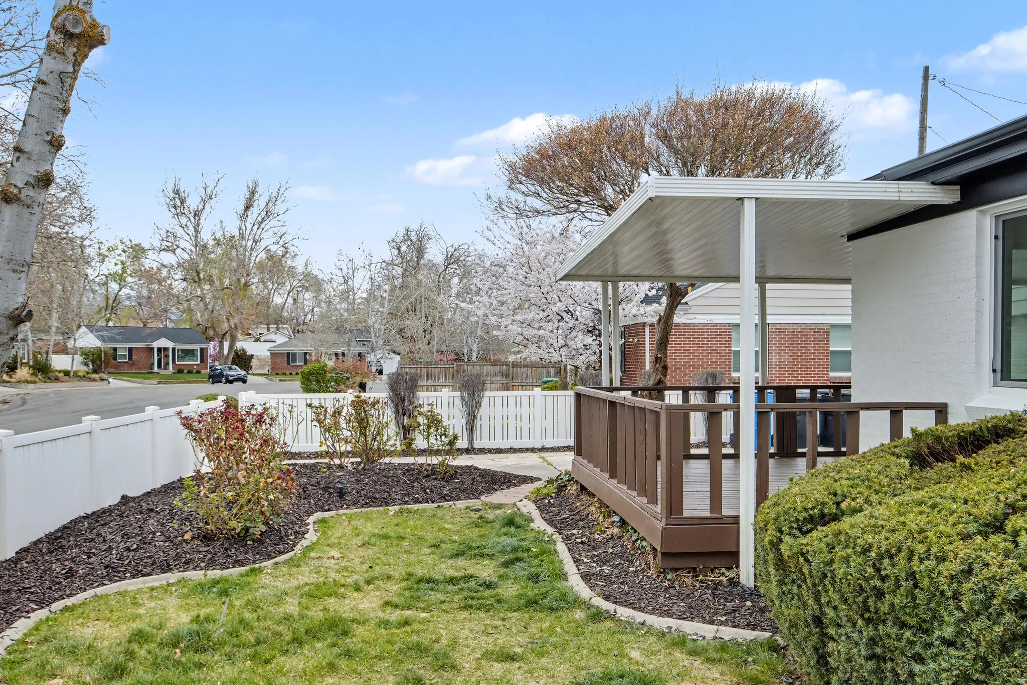 Fenced backyard featuring a deck and a residential view