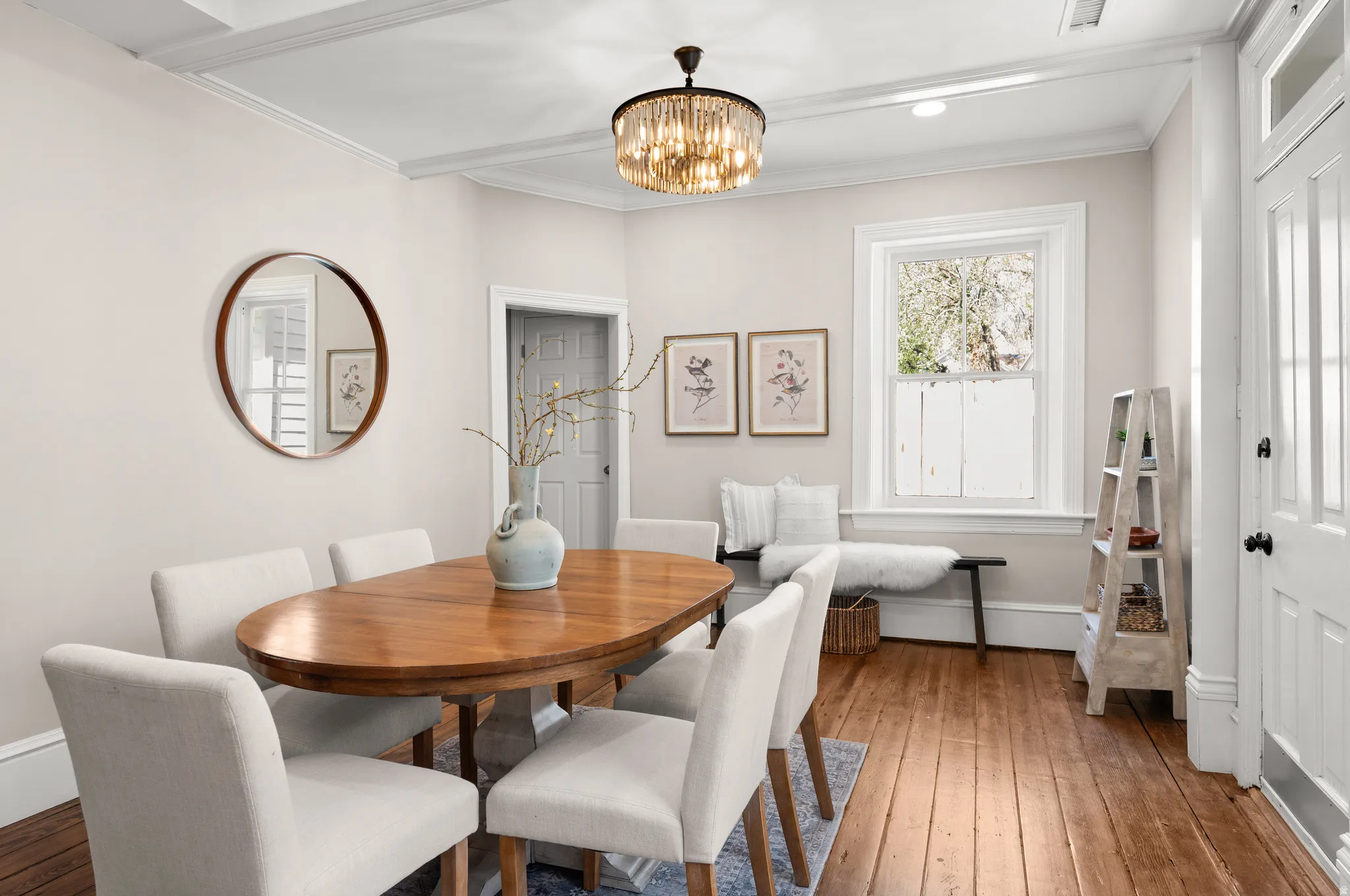 Dining space featuring chandelier, decorative ceiling, original wood flooring