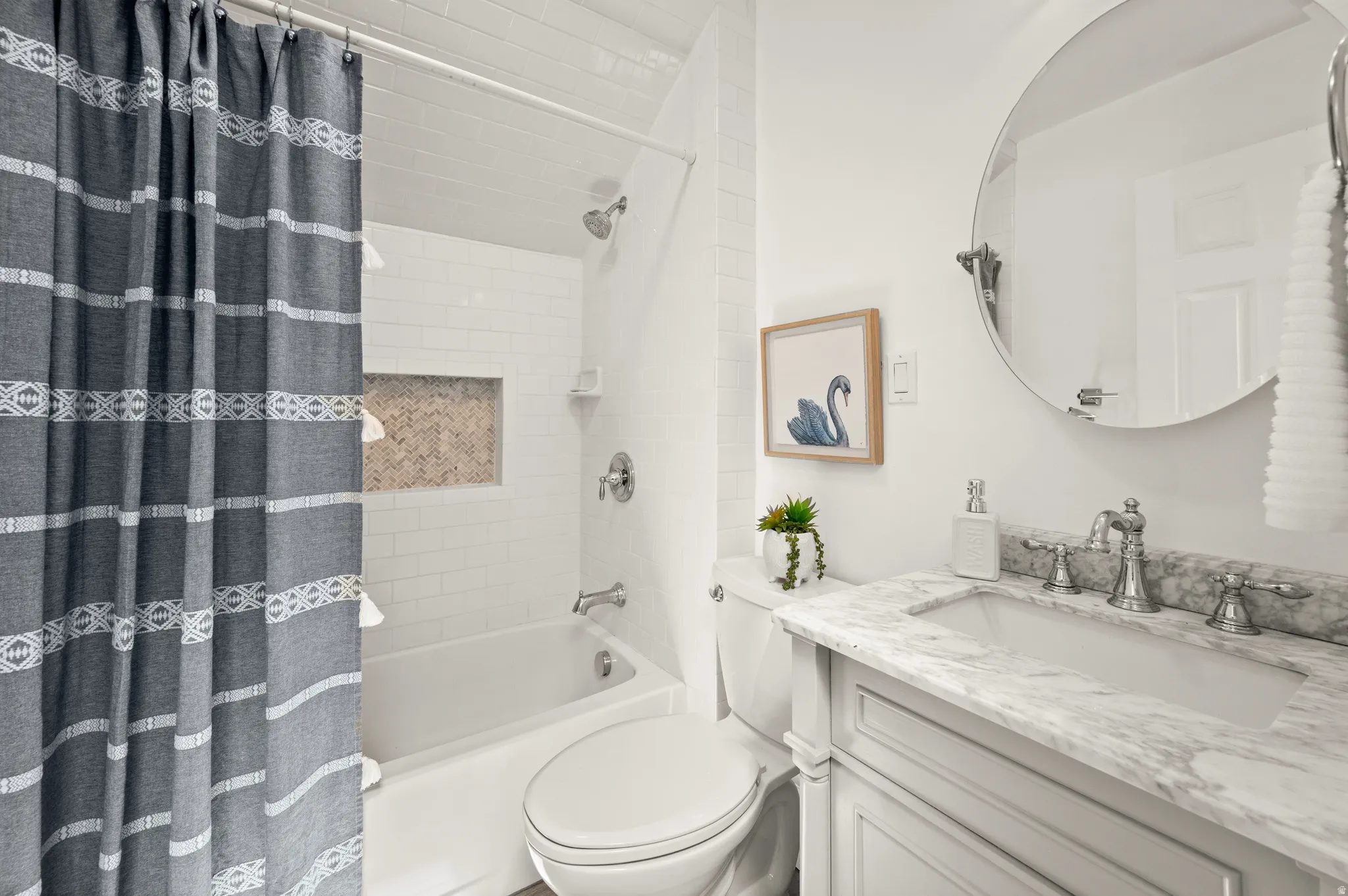 Bathroom featuring vanity and shower / bath combo with shower curtain