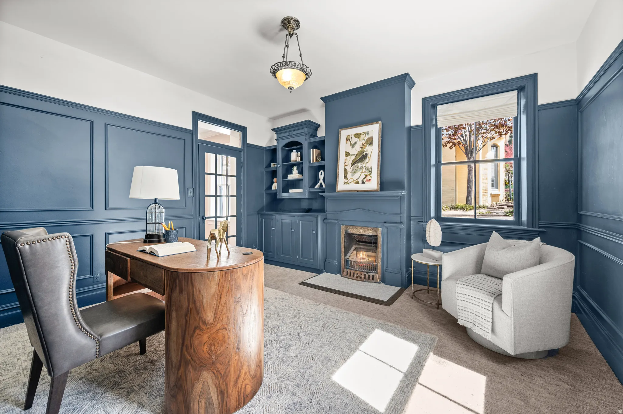 Office with a decorative wall, light colored carpet, and a premium fireplace