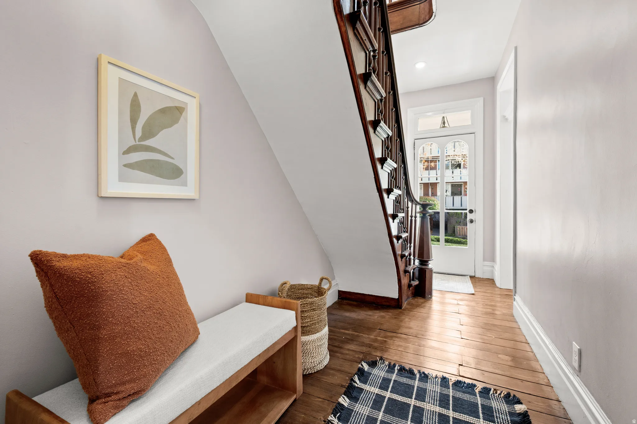 Entryway with dark wood-type flooring and stairway