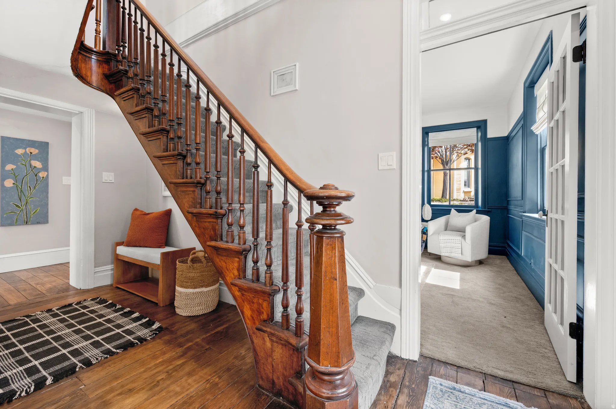 Staircase featuring hardwood / wood-style flooring and baseboards