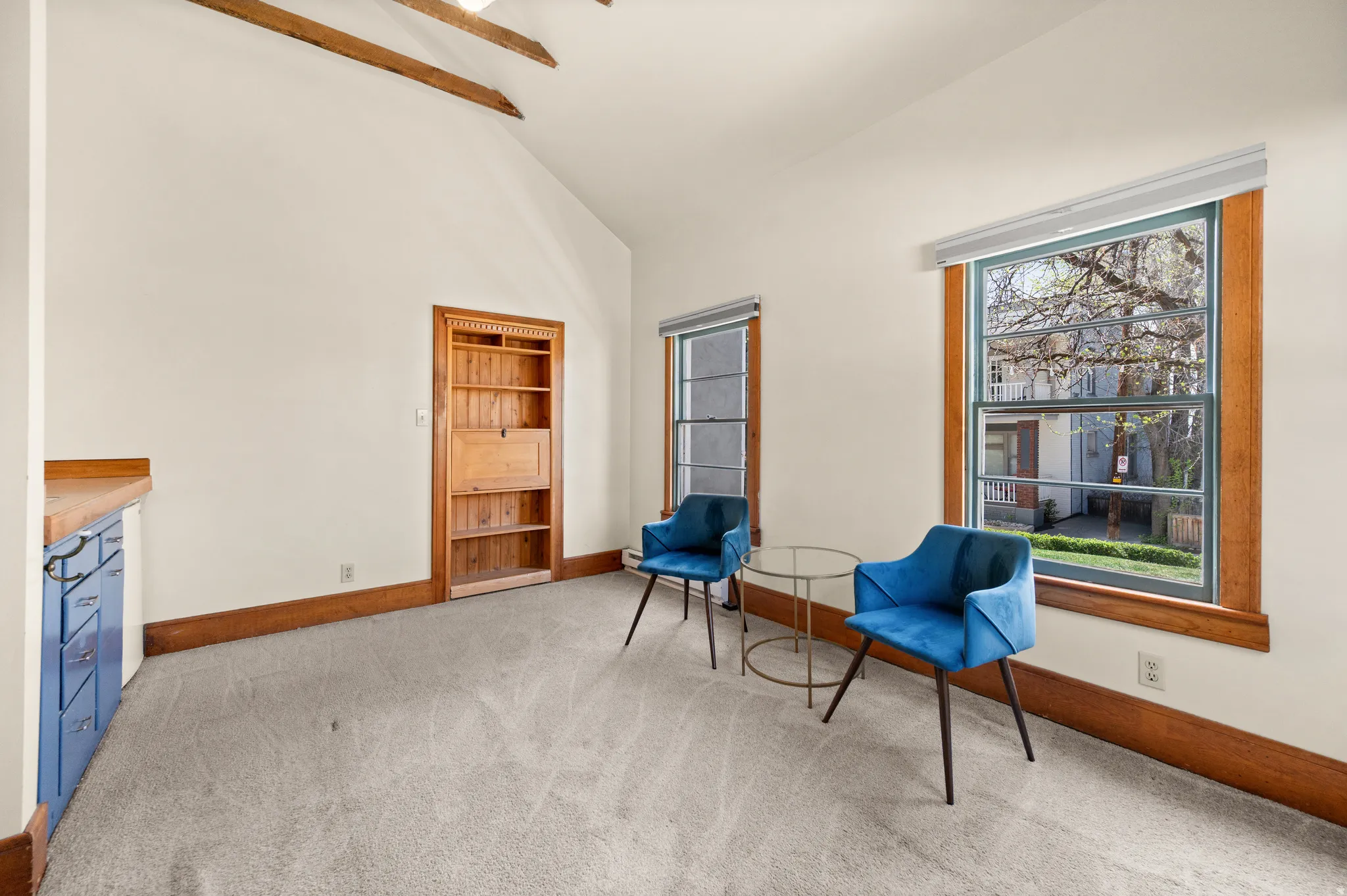 Living area featuring light colored carpet and lofted ceiling