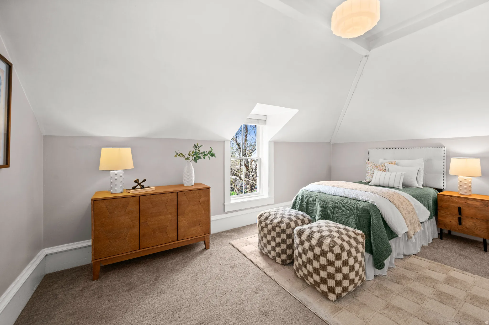 Bedroom with vaulted ceiling and carpet