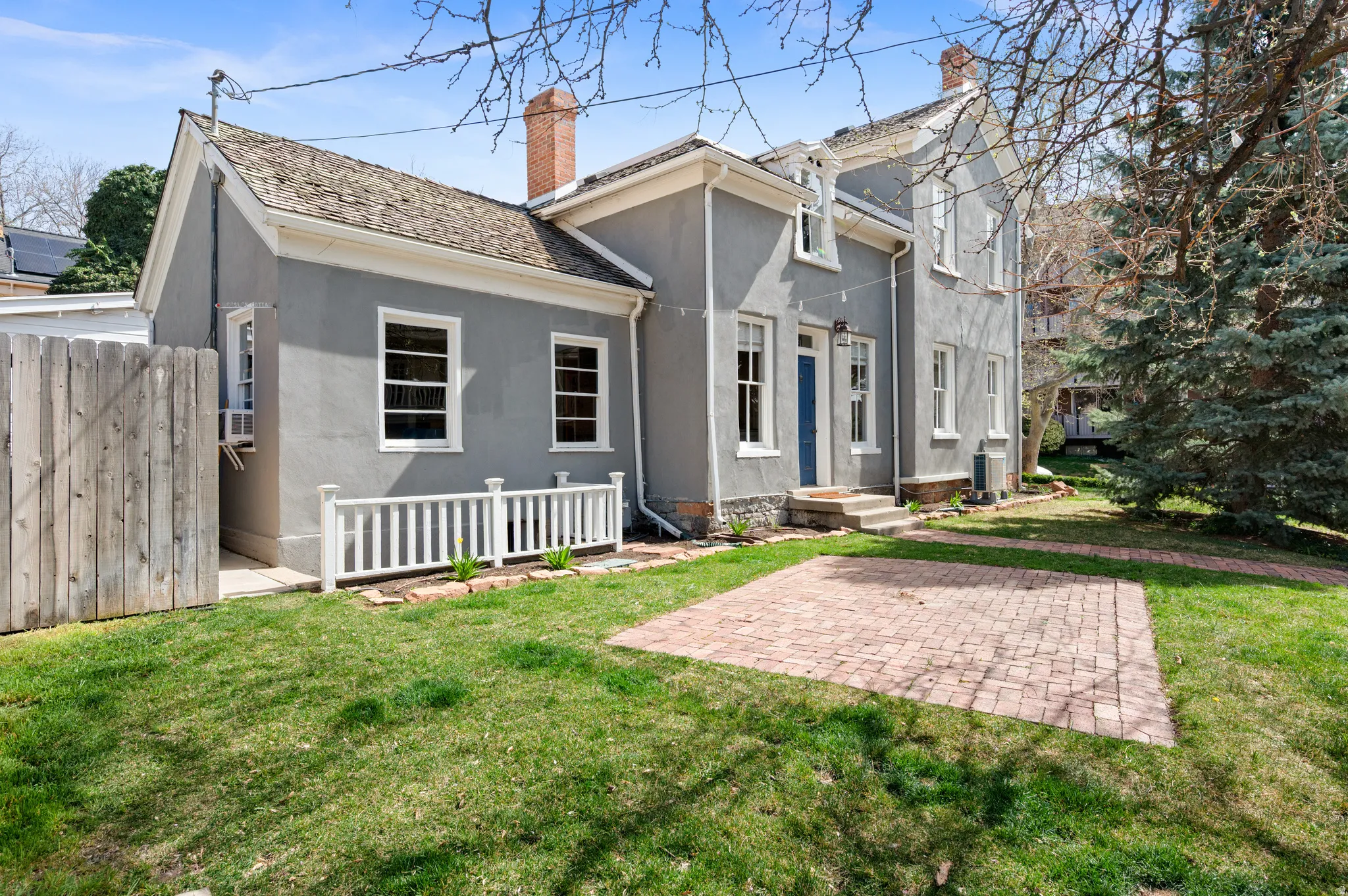 Back of property with stucco siding and a chimney