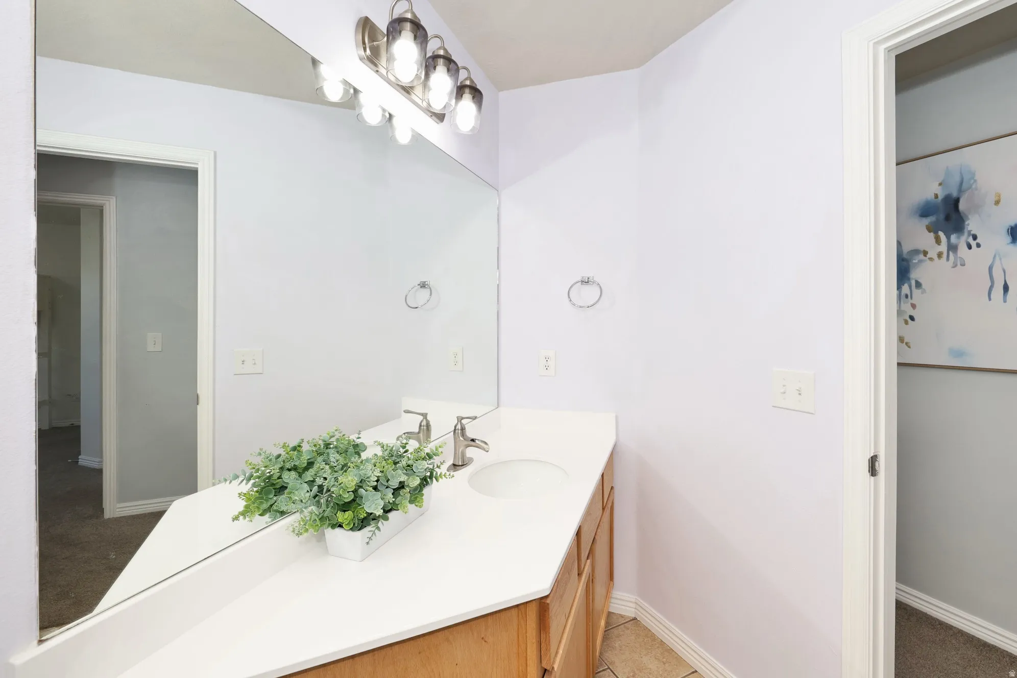 Bathroom featuring vanity and baseboards