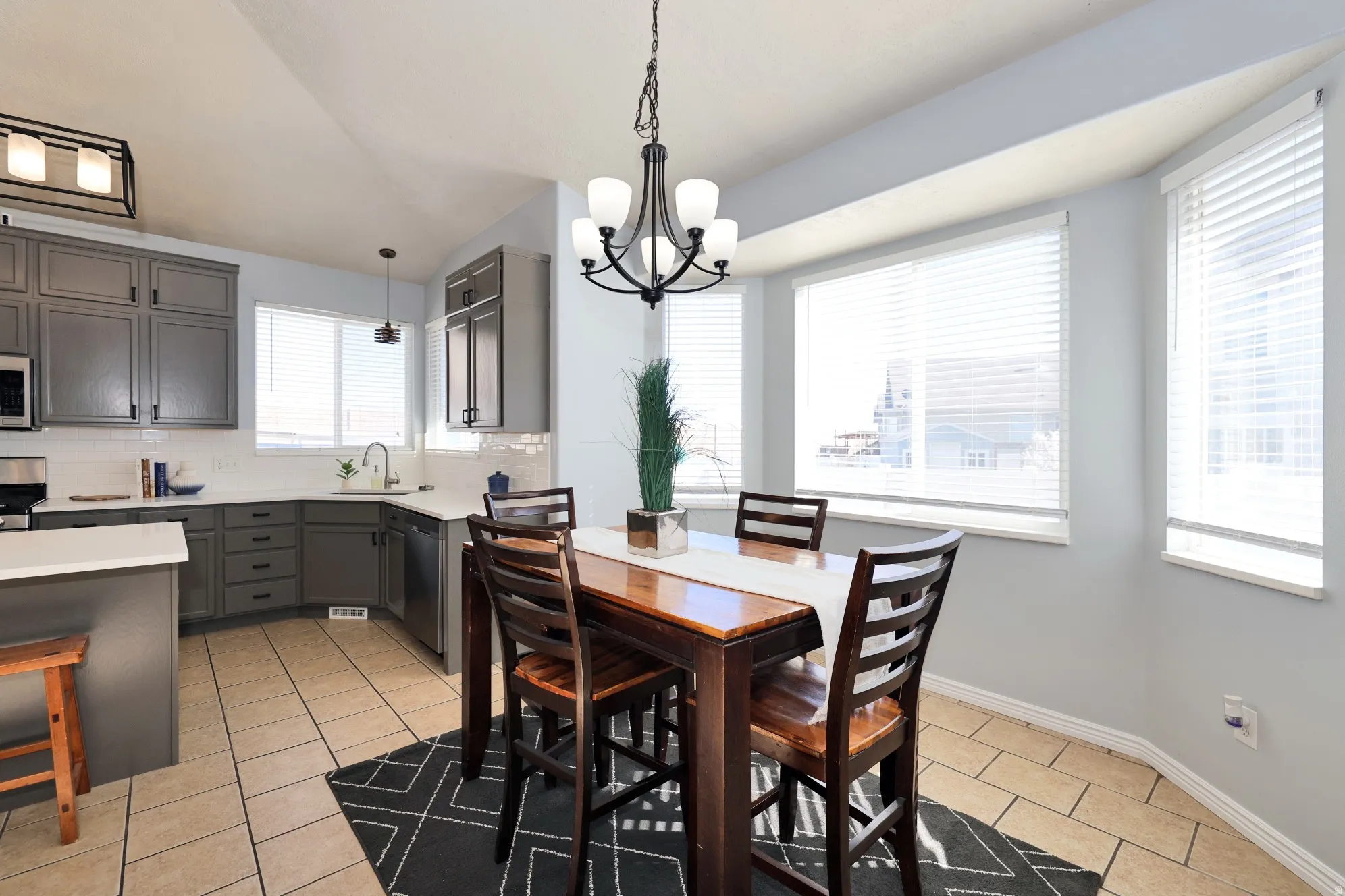 Dining space featuring light tile patterned floors and a chandelier