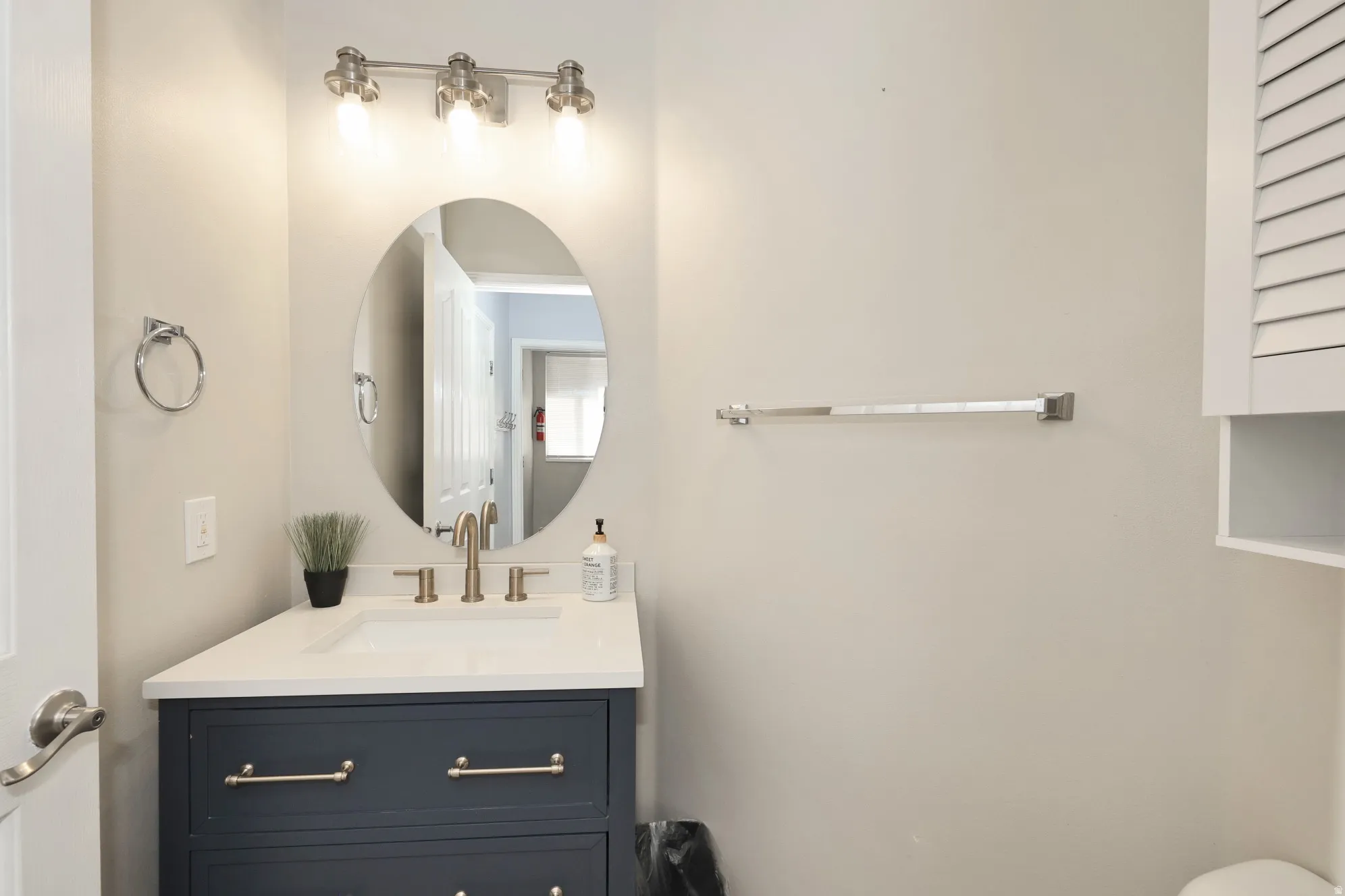 Half bathroom featuring vanity