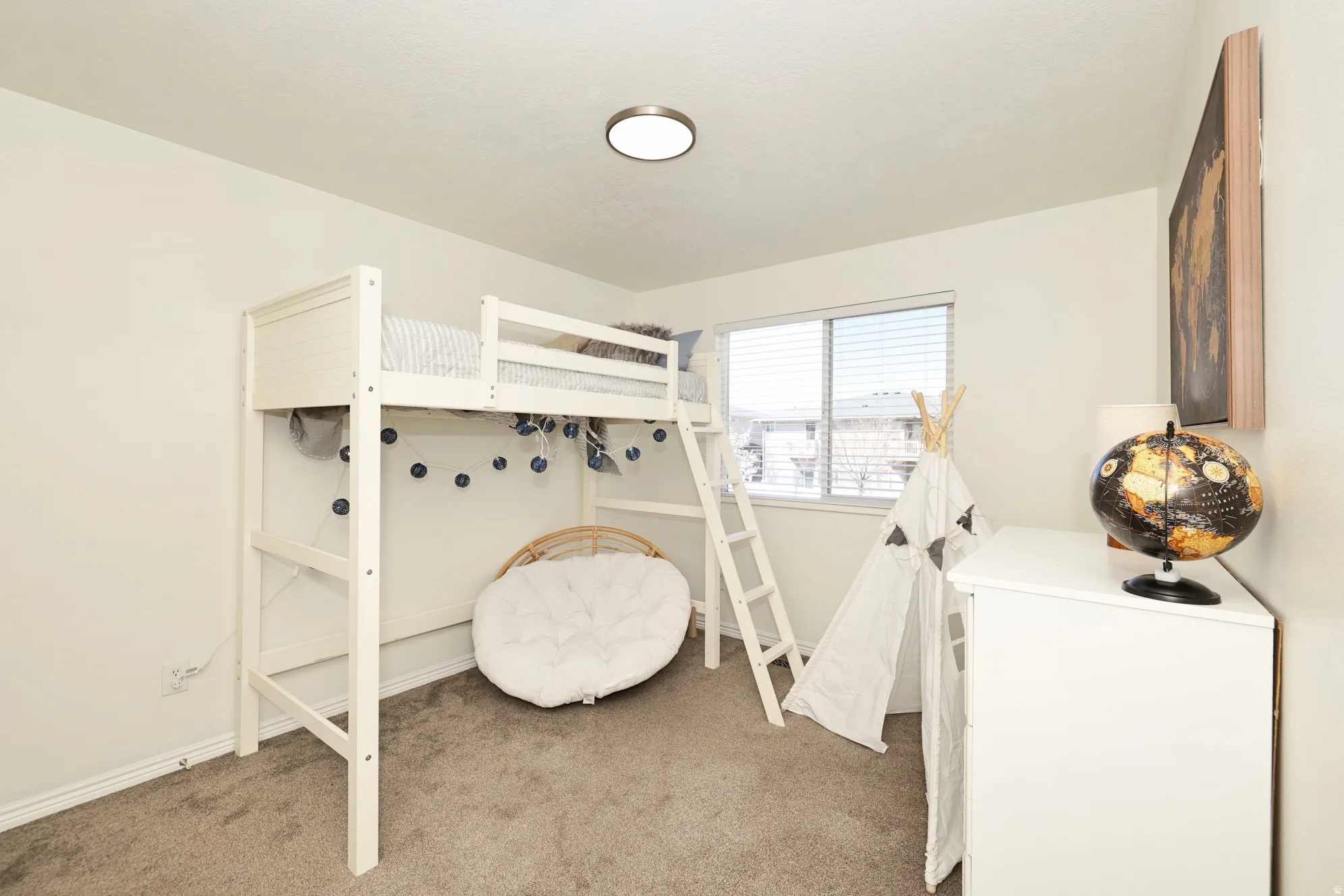 Bedroom with light carpet and baseboards