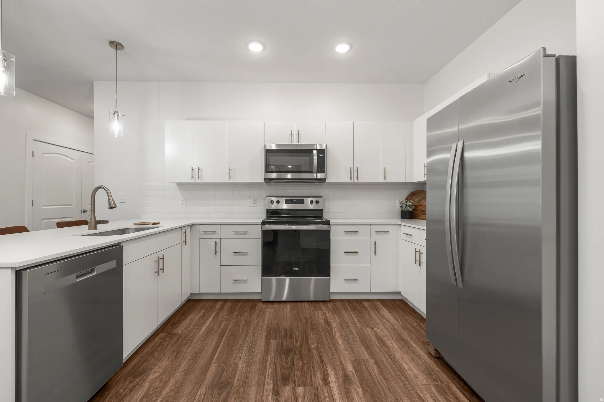 Bright white kitchen with stainless steel appliances. *fridge not included*