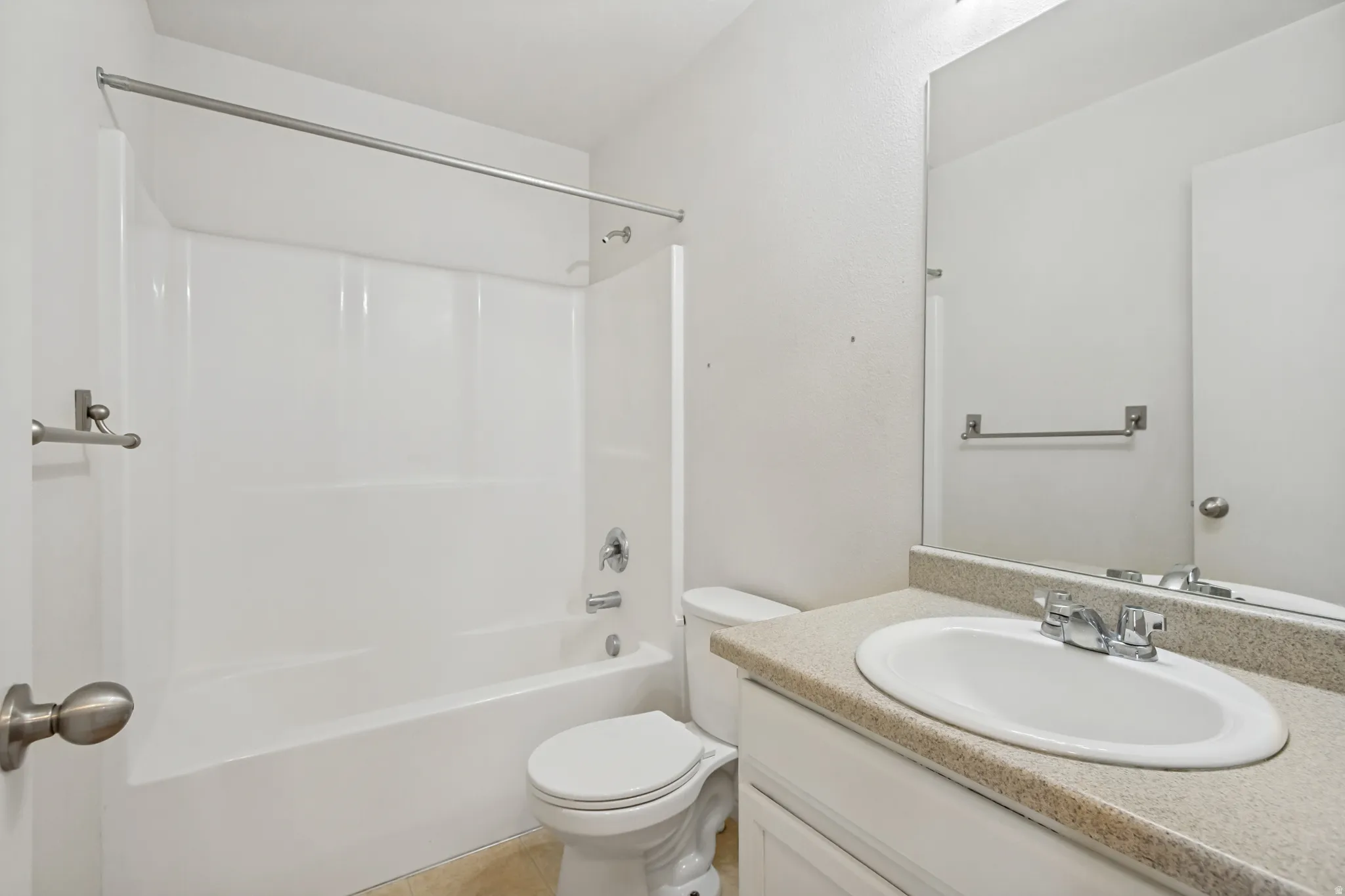 Bathroom featuring a white bathtub and shower combination with a curved shower rod