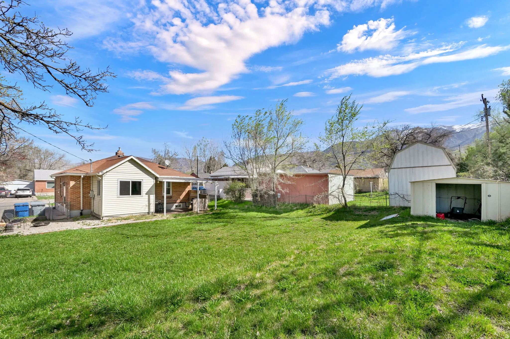 View of yard featuring an outbuilding, a patio, and a barn