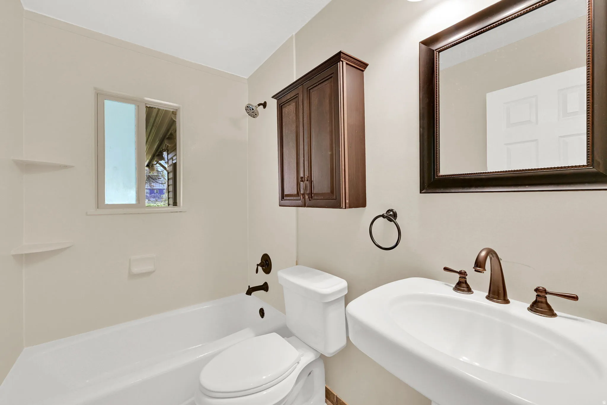 Bathroom featuring toilet and washtub / shower combination