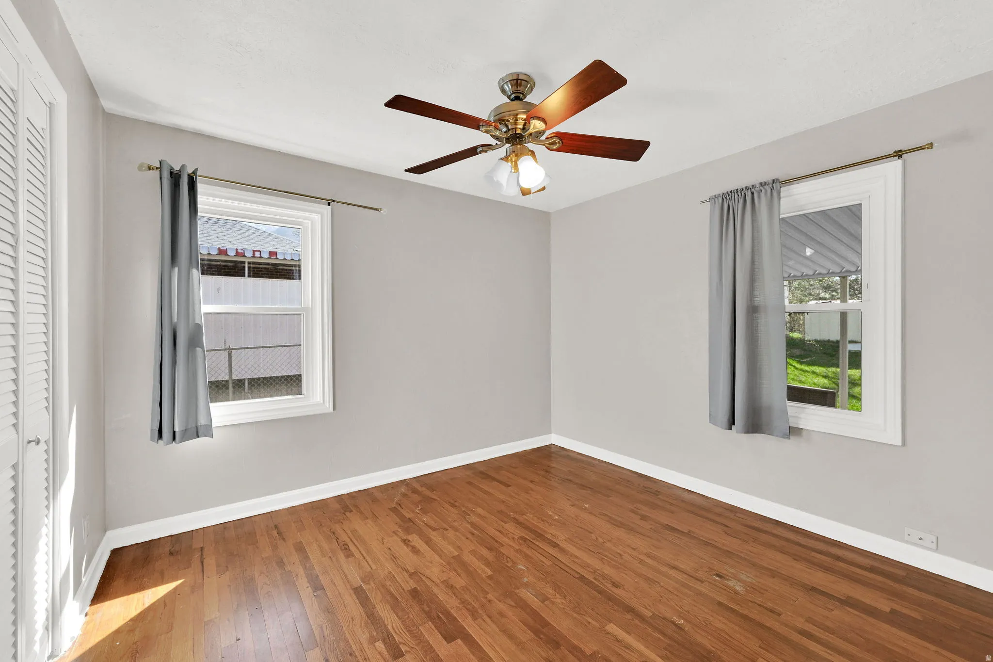 Spare room featuring hardwood / wood-style floors and a ceiling fan