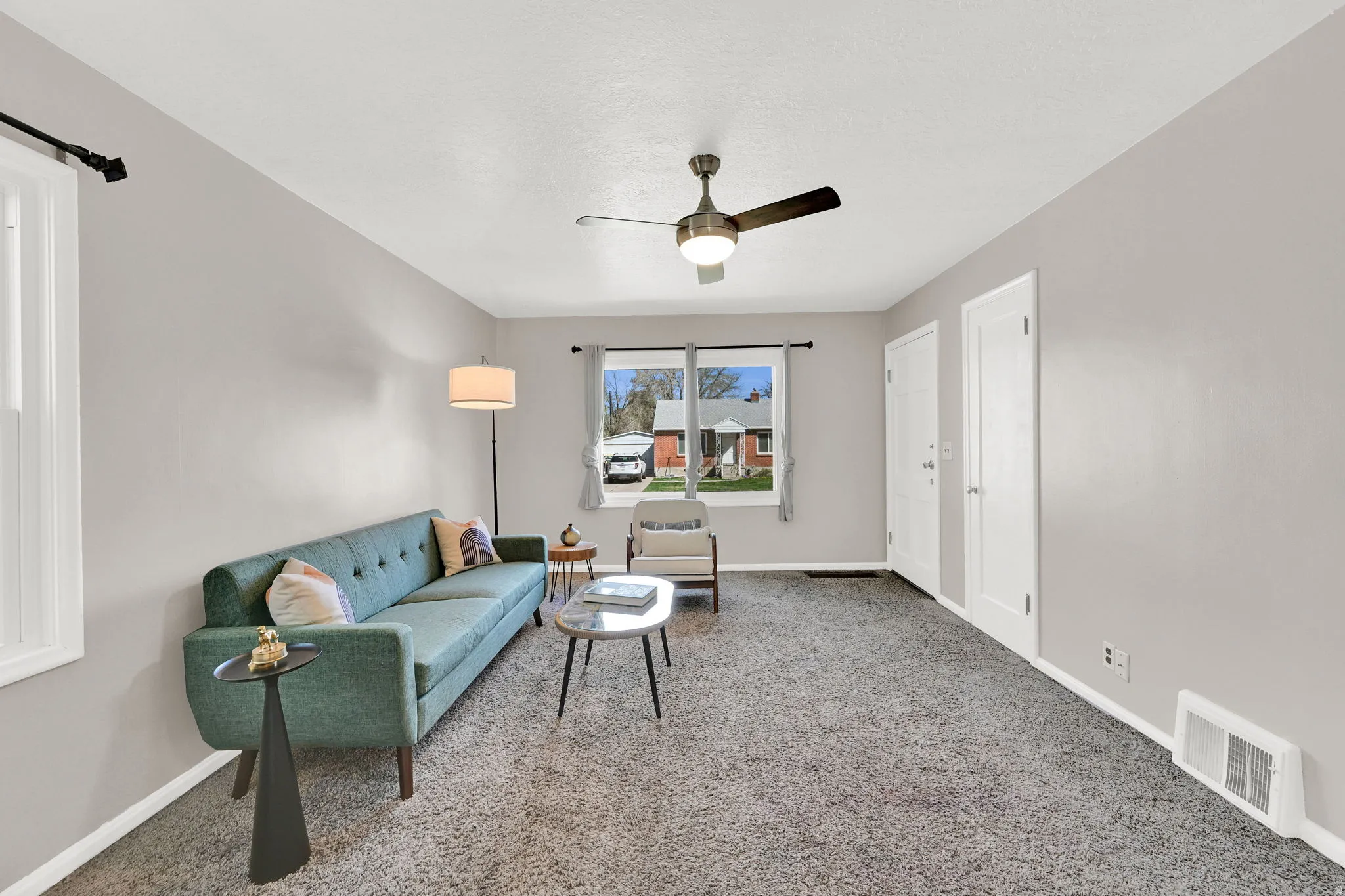 Living area featuring a ceiling fan and carpet floors