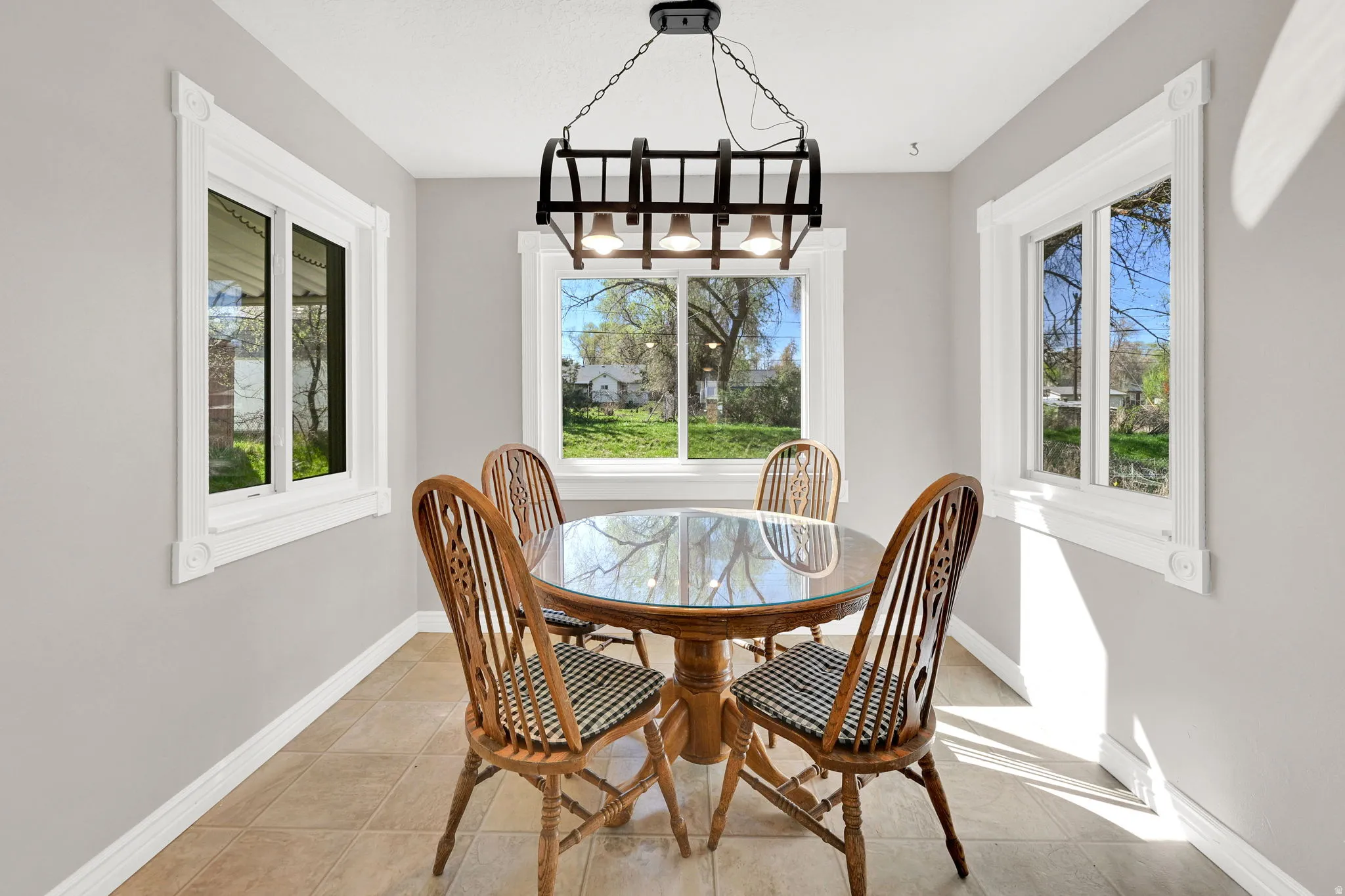 Dining space with baseboards and light tile patterned floors