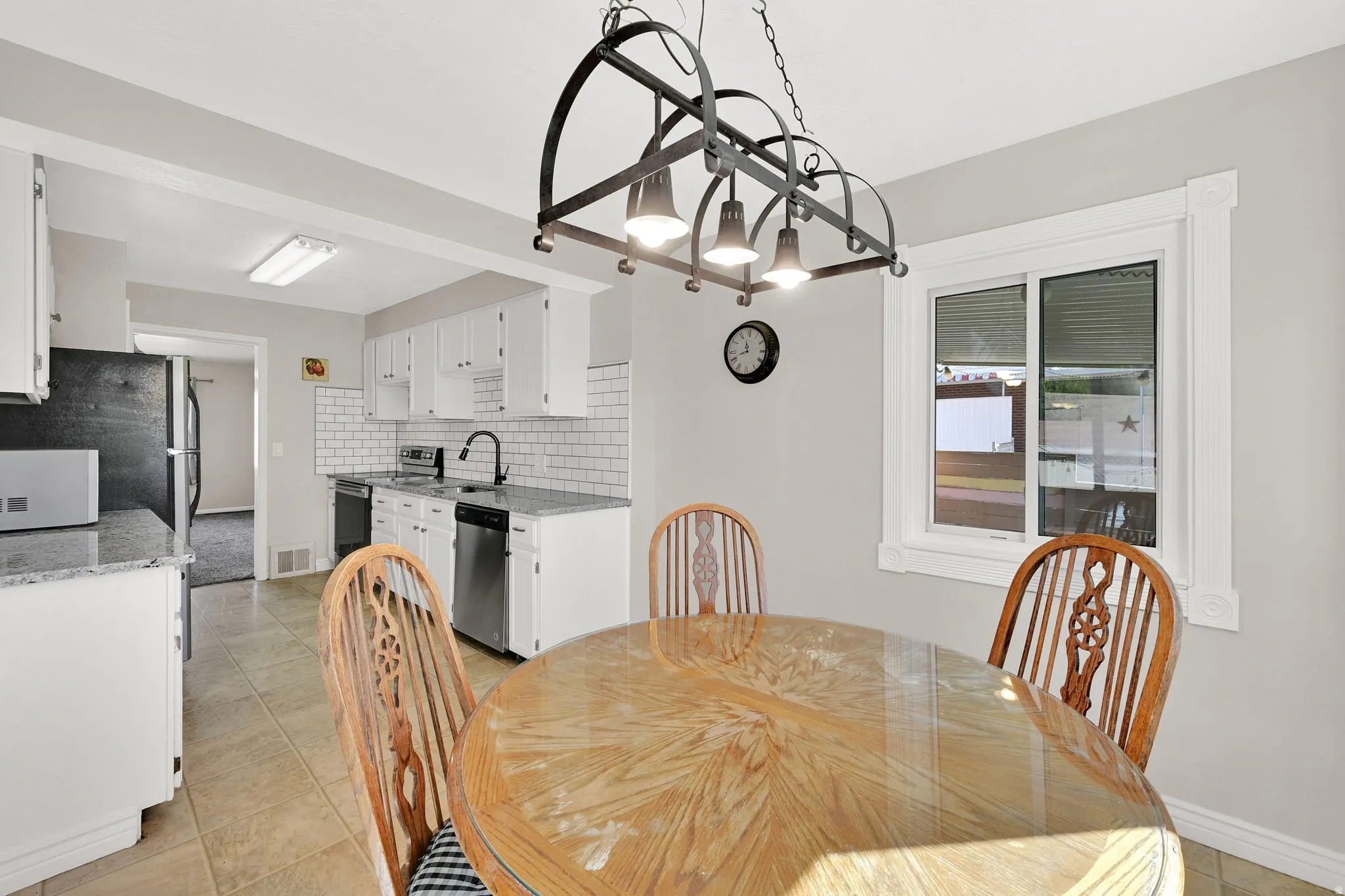 Dining room featuring light tile patterned flooring and a chandelier