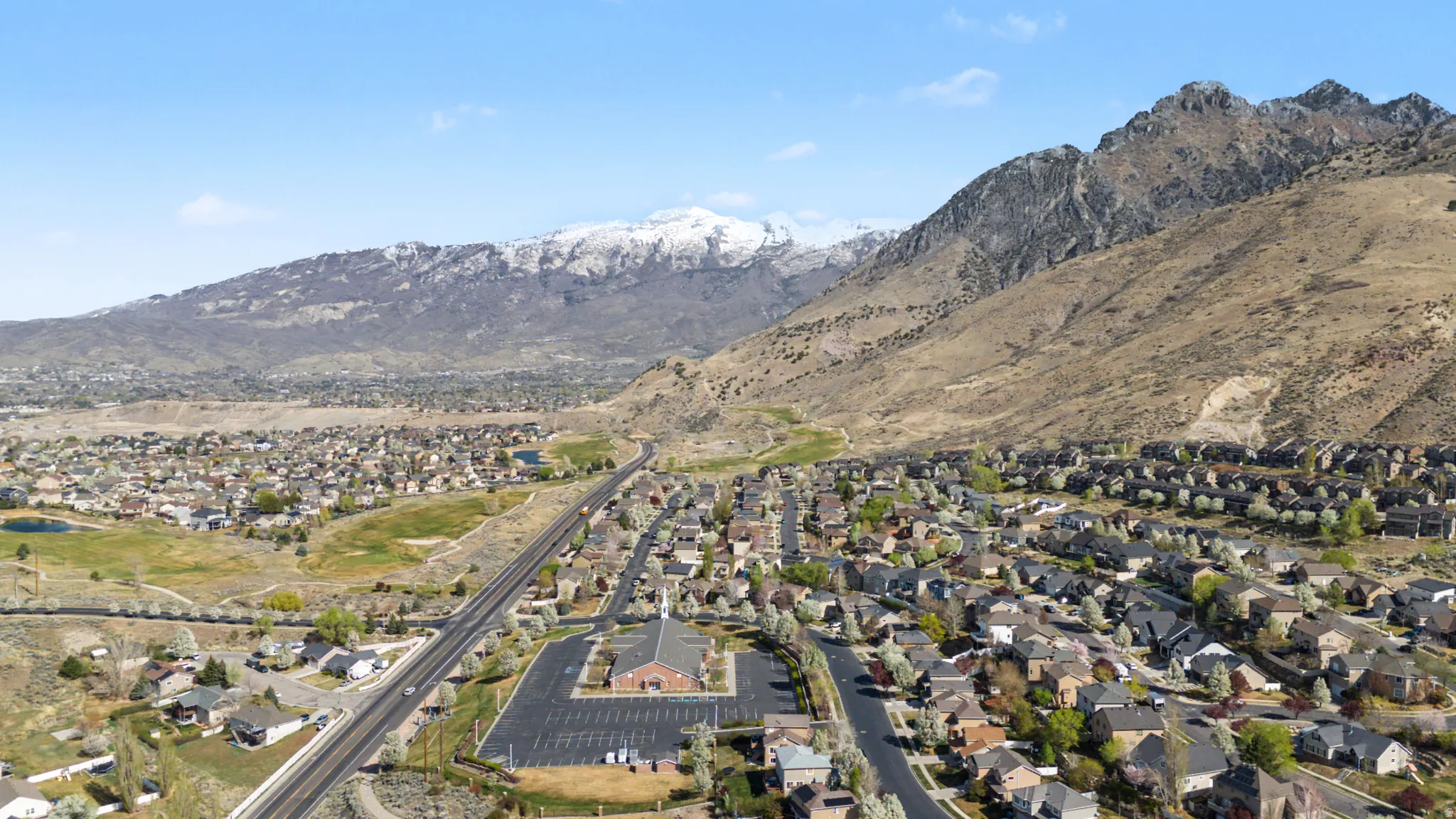 Aerial perspective of suburban area featuring a mountainous background