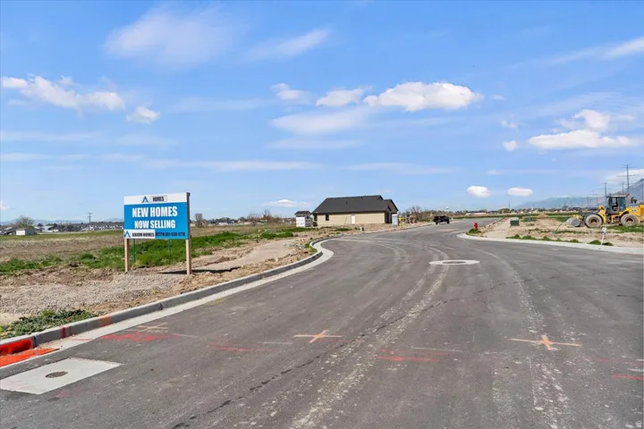 View of asphalt street featuring curbs
