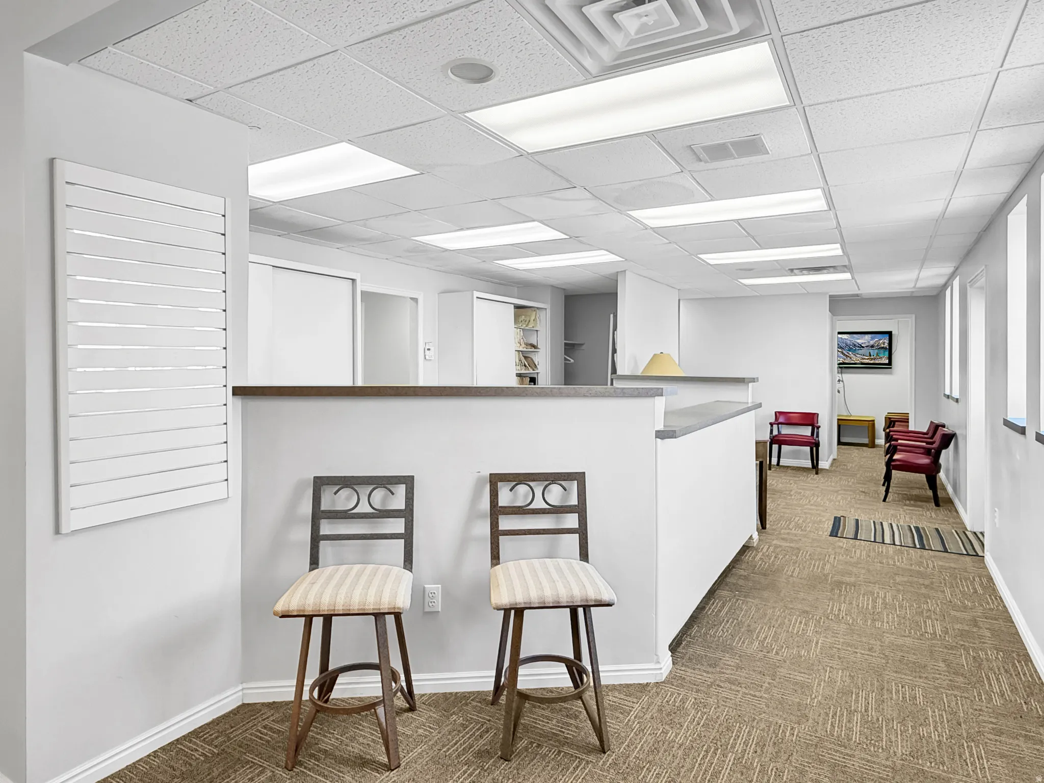 Kitchen featuring a paneled ceiling and a breakfast bar