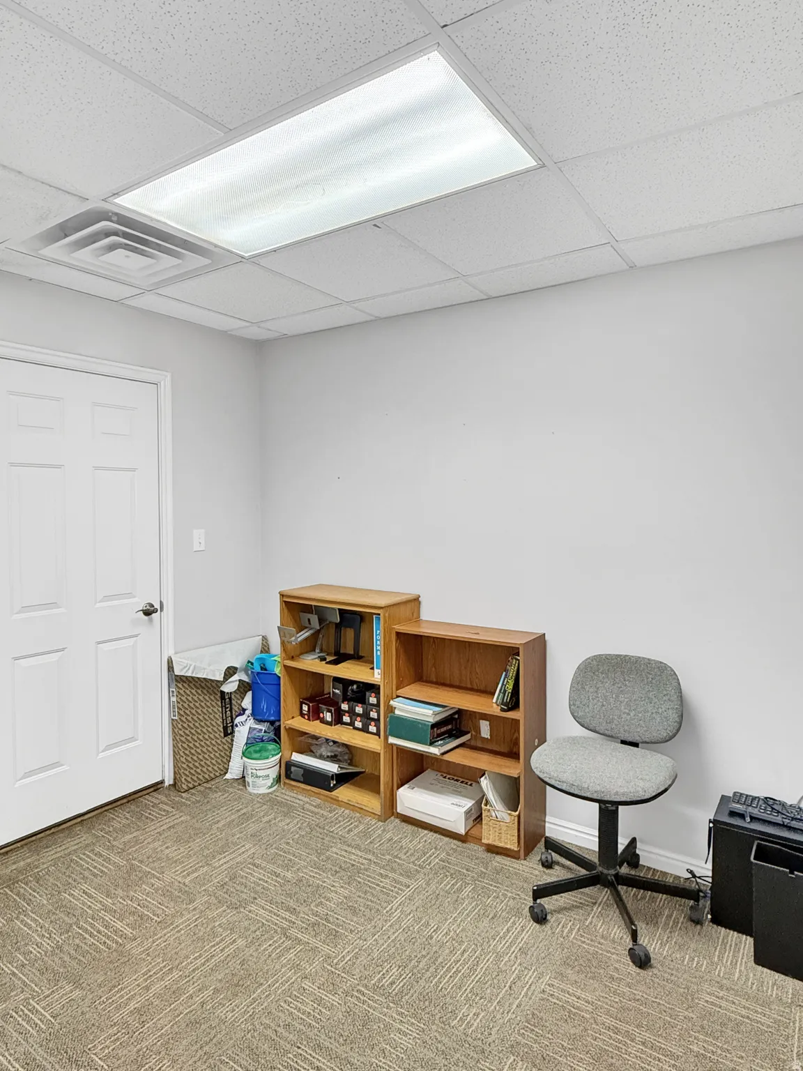 Playroom with a paneled ceiling and carpet floors