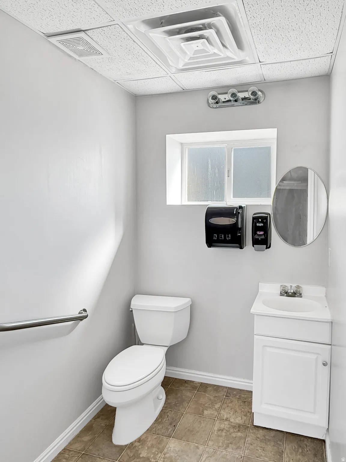 Half bathroom with vanity and a drop ceiling