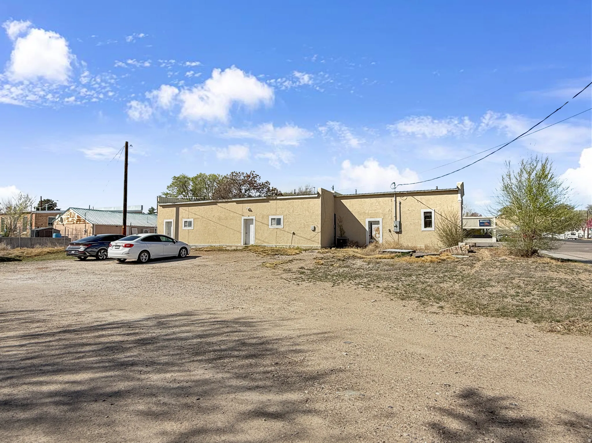 View of property with uncovered parking