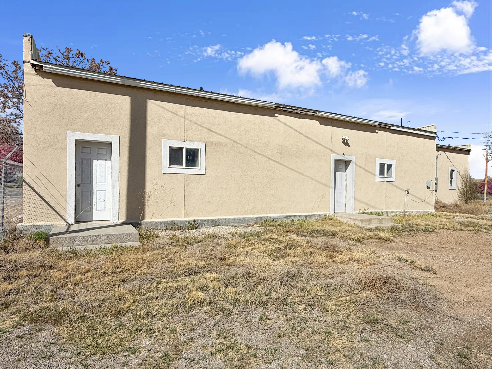 Back of house featuring stucco siding