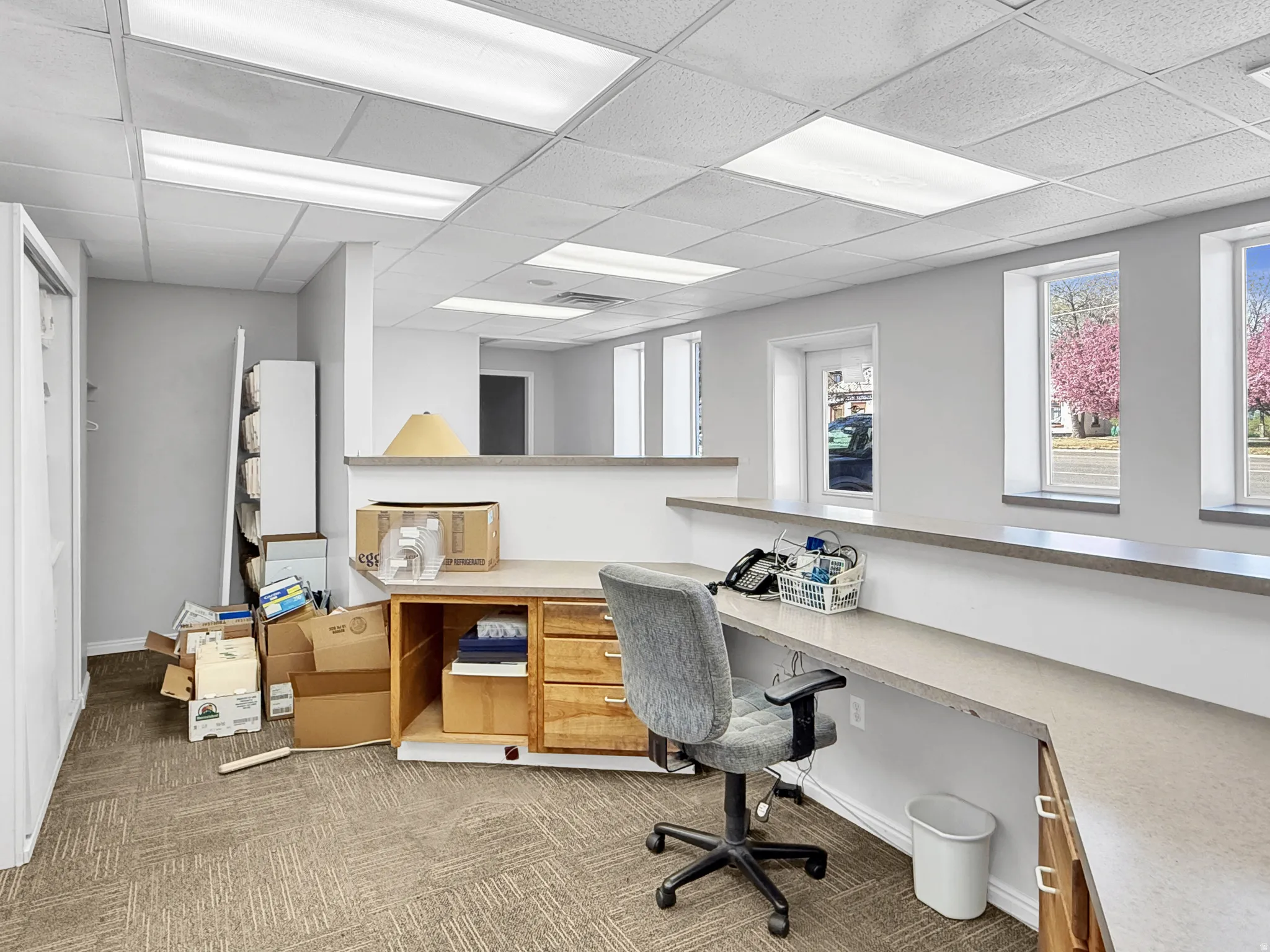 Office area featuring a paneled ceiling and built in study area