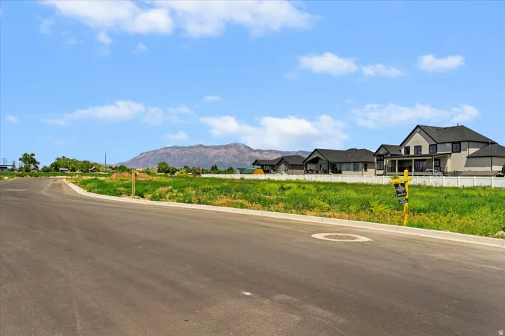 View of asphalt street with curbs and a mountain view
