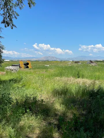 View of undeveloped land featuring a mountain backdrop and rural landscape
