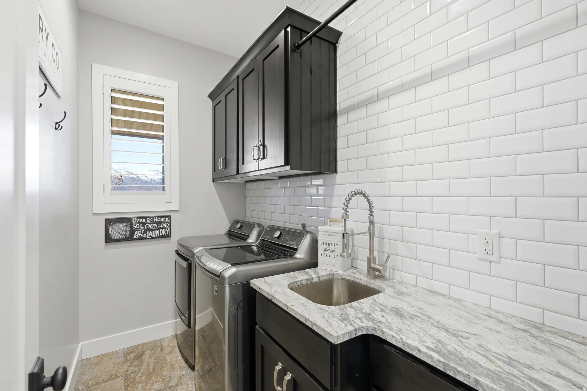 Laundry room featuring washing machine and clothes dryer and cabinet space