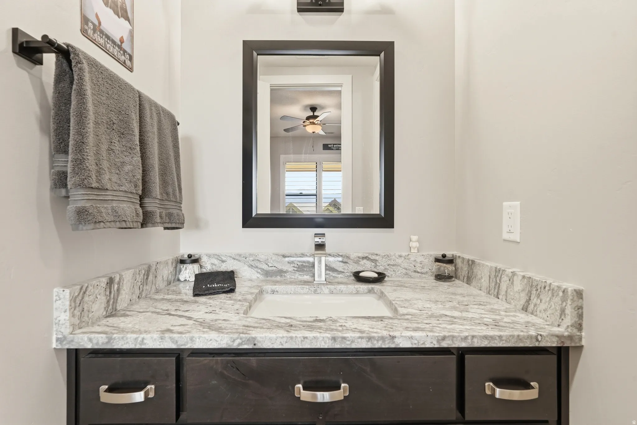 Bathroom featuring vanity and ceiling fan