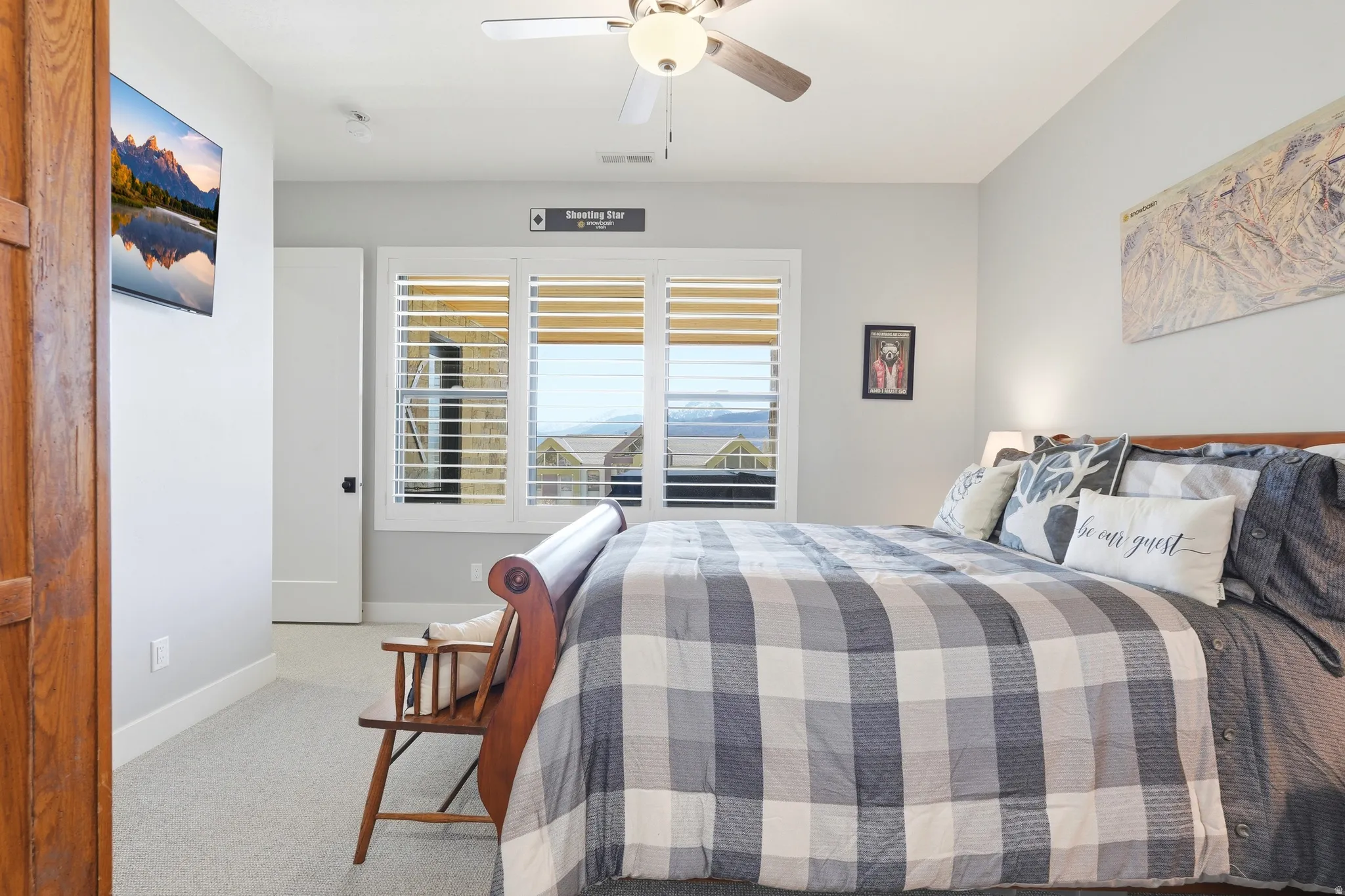 Bedroom featuring light carpet and a ceiling fan