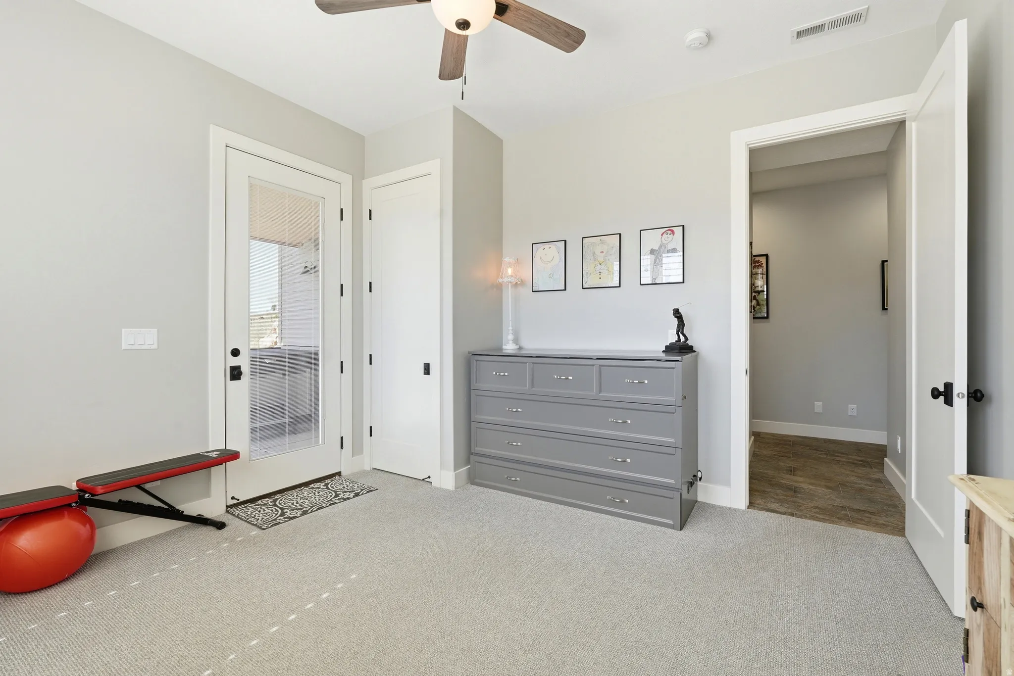 Bedroom featuring light colored carpet and a ceiling fan