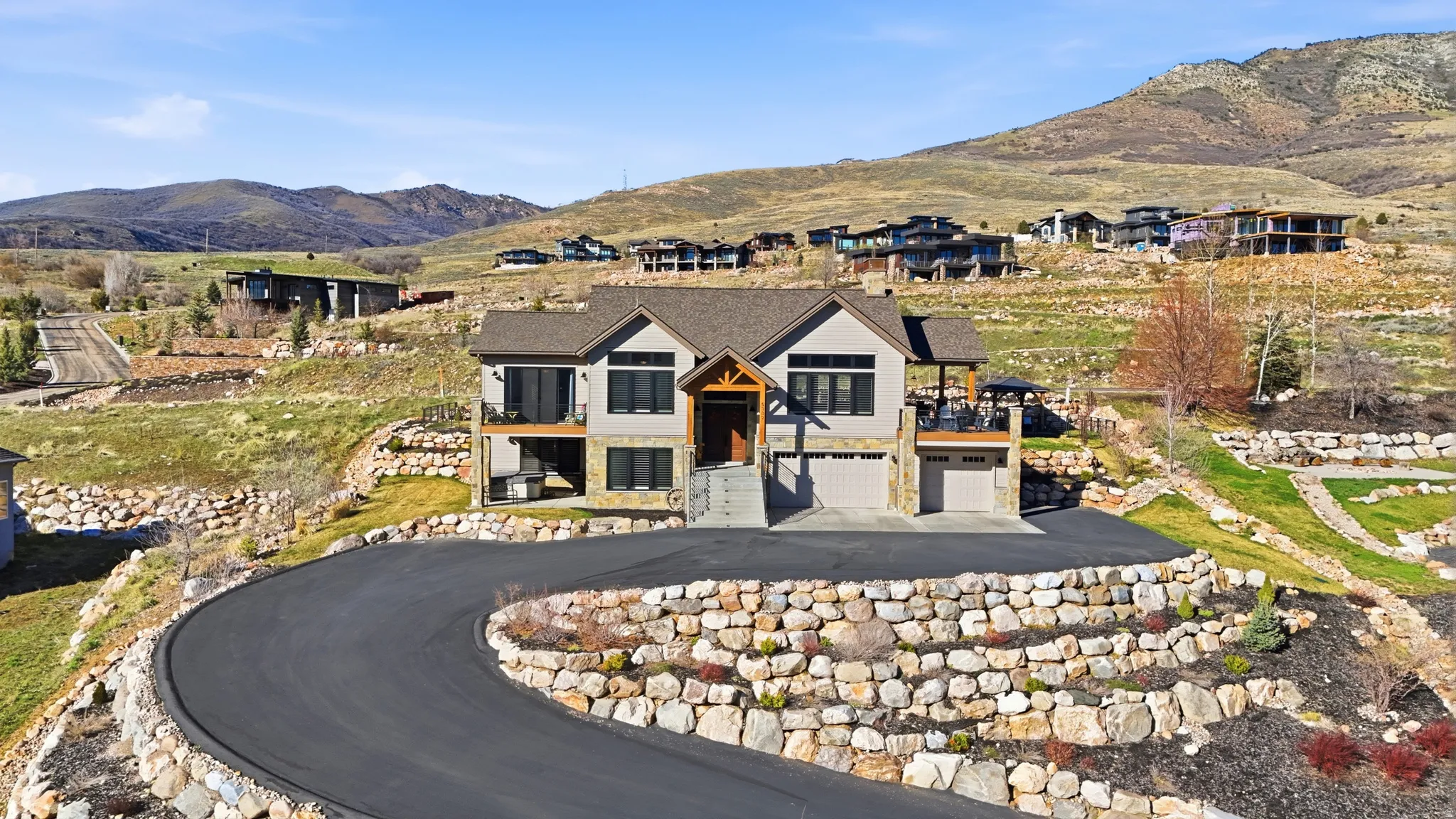 View of front facade with a mountain view, an attached garage, and asphalt driveway