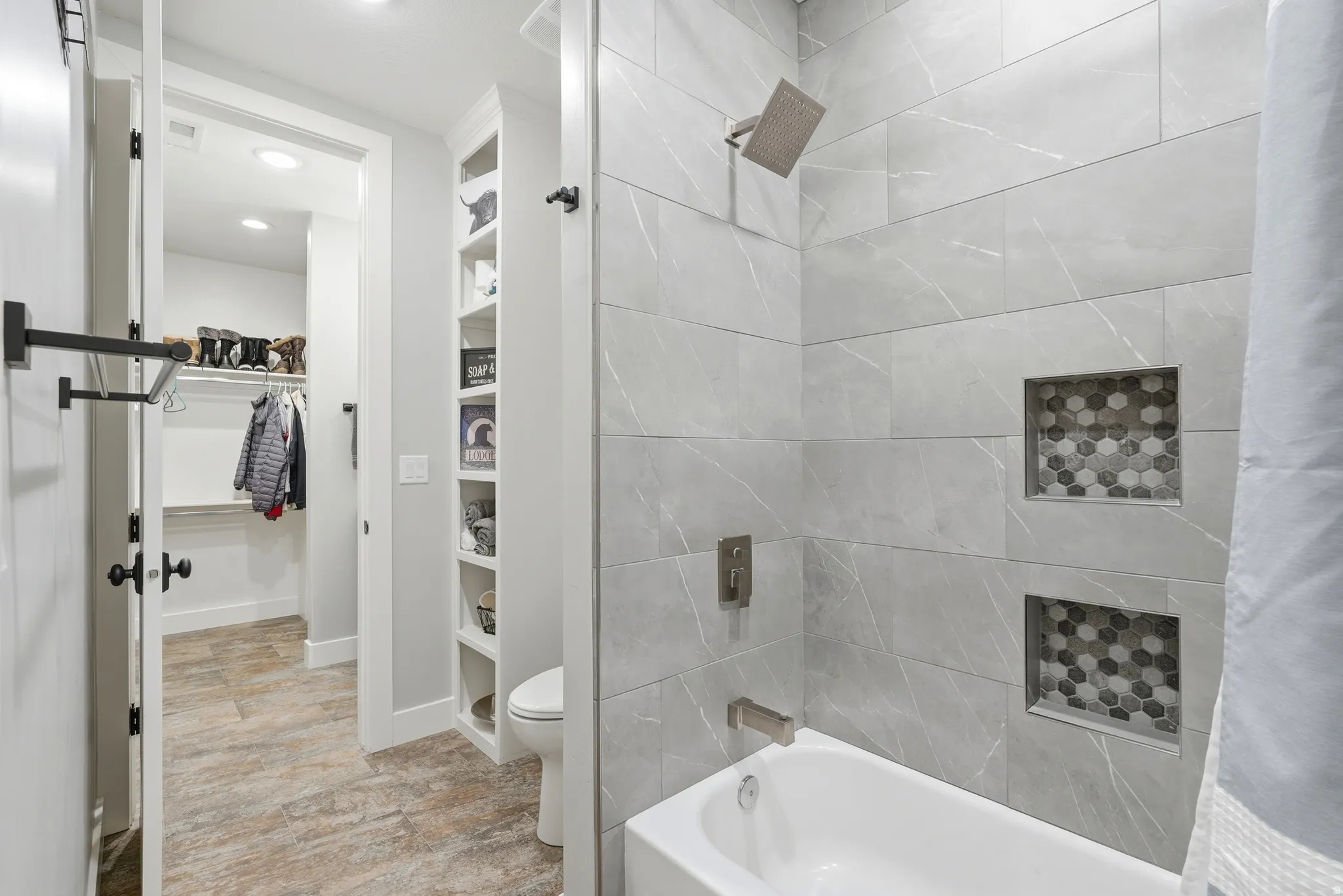 Bathroom featuring a spacious closet, built in features, shower / tub combo with curtain, and recessed lighting