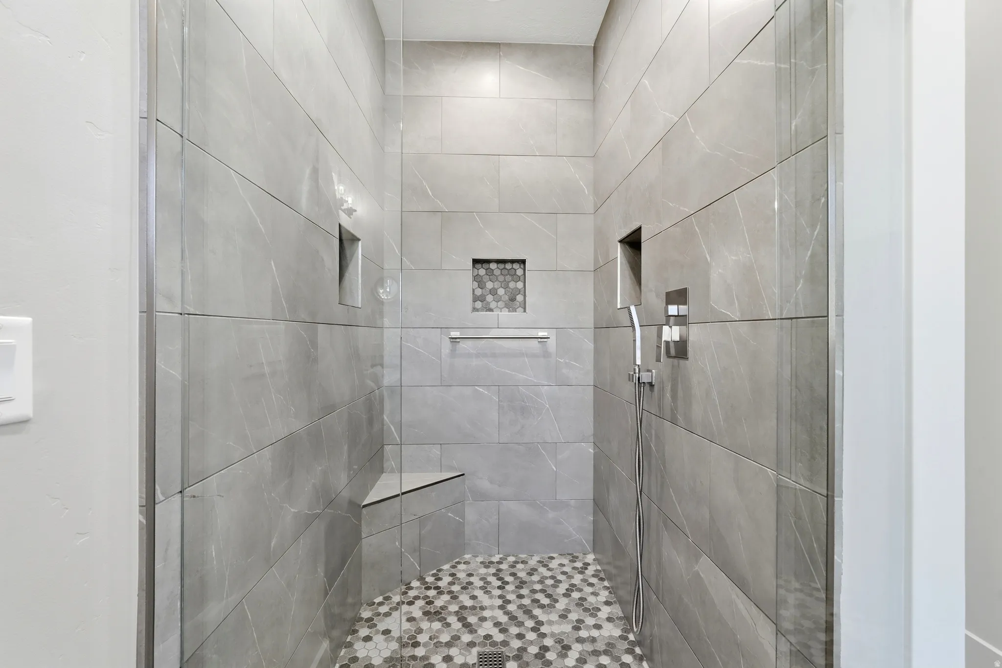 Full bath with a tile shower