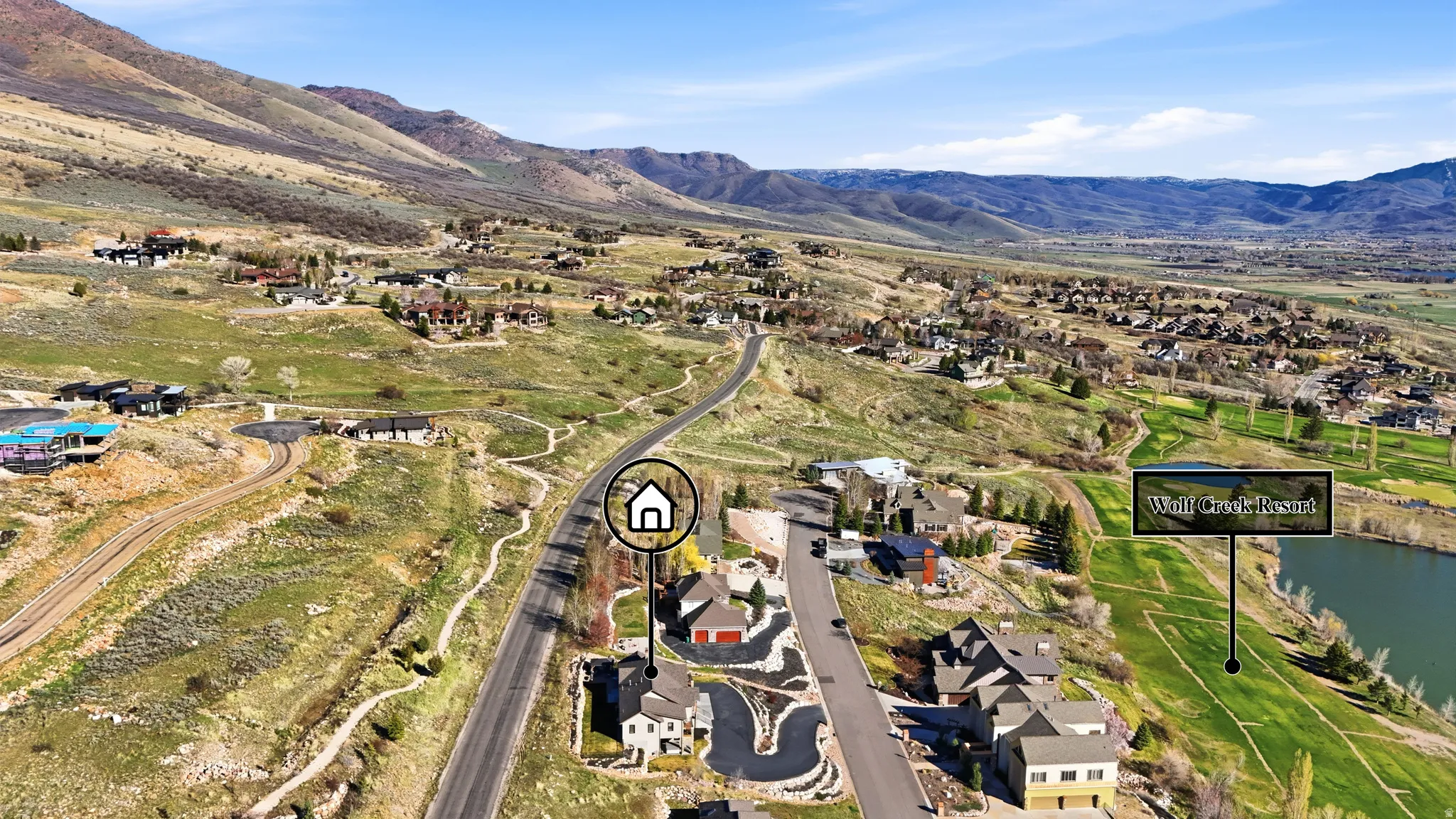 Aerial view of property and surrounding area with nearby suburban area and a water and mountain view