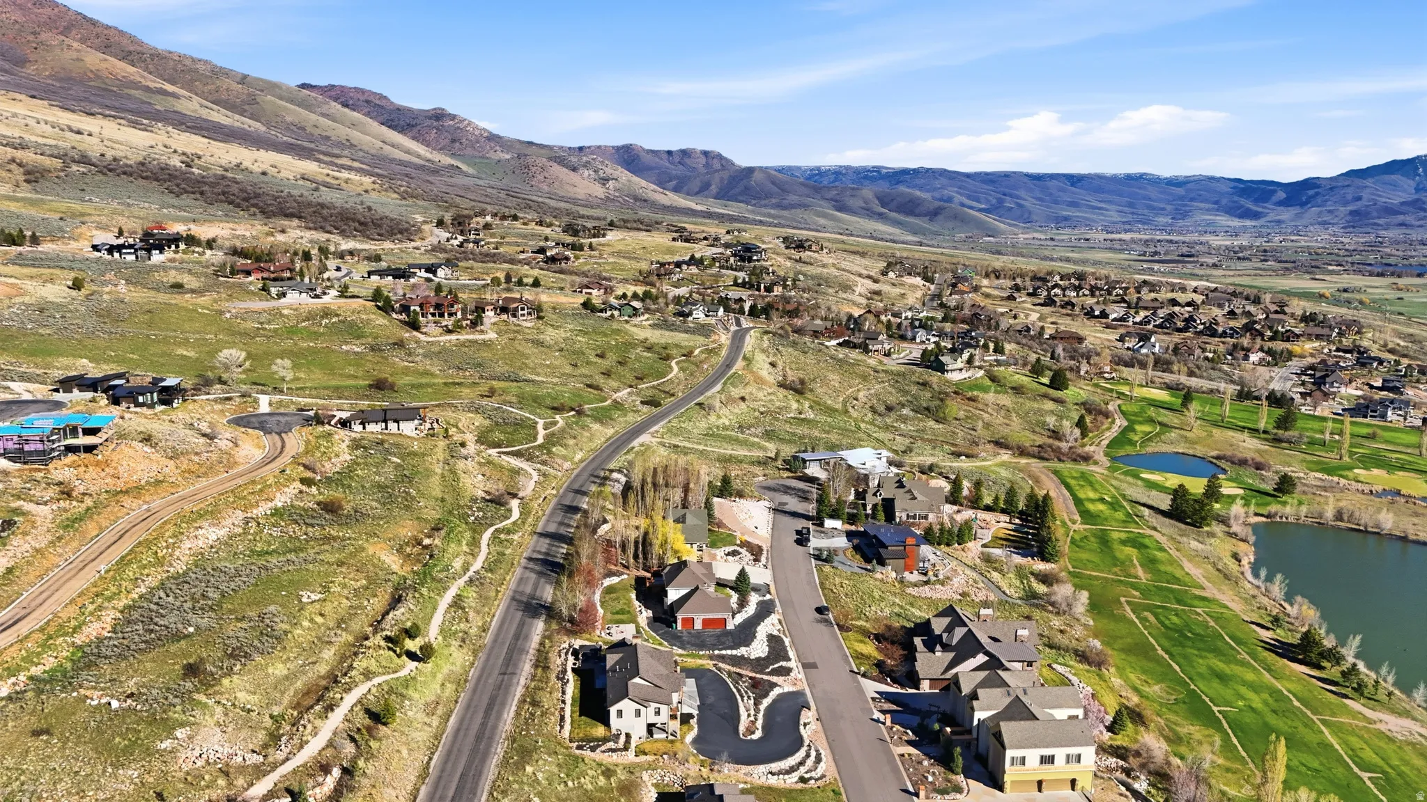 Aerial perspective of suburban area featuring a water and mountain view