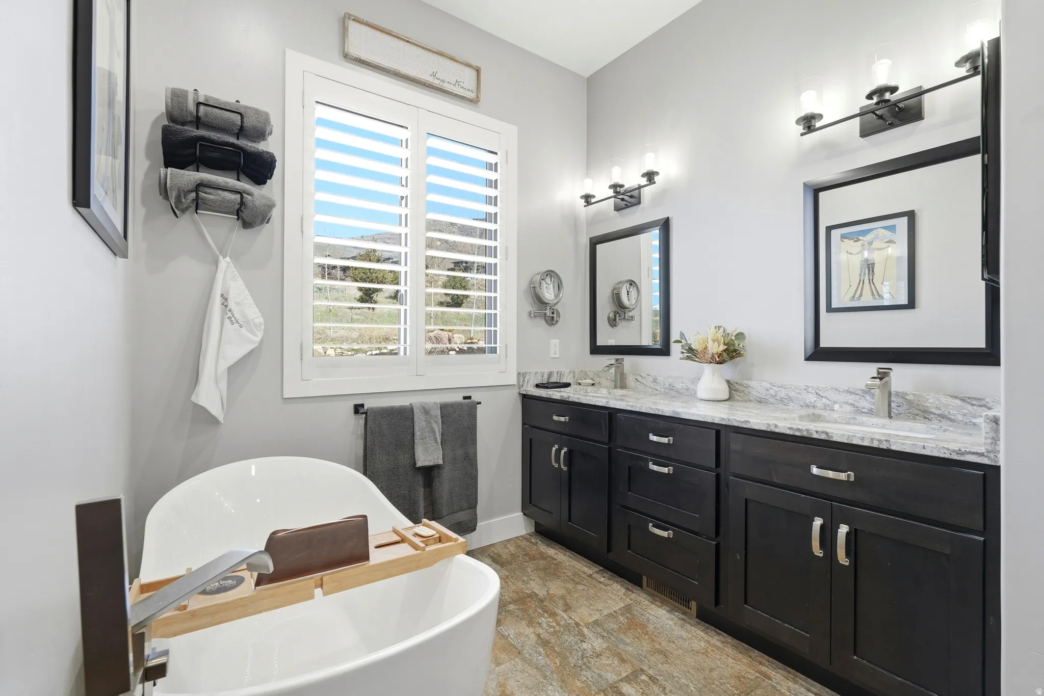 Bathroom featuring double vanity and a soaking tub