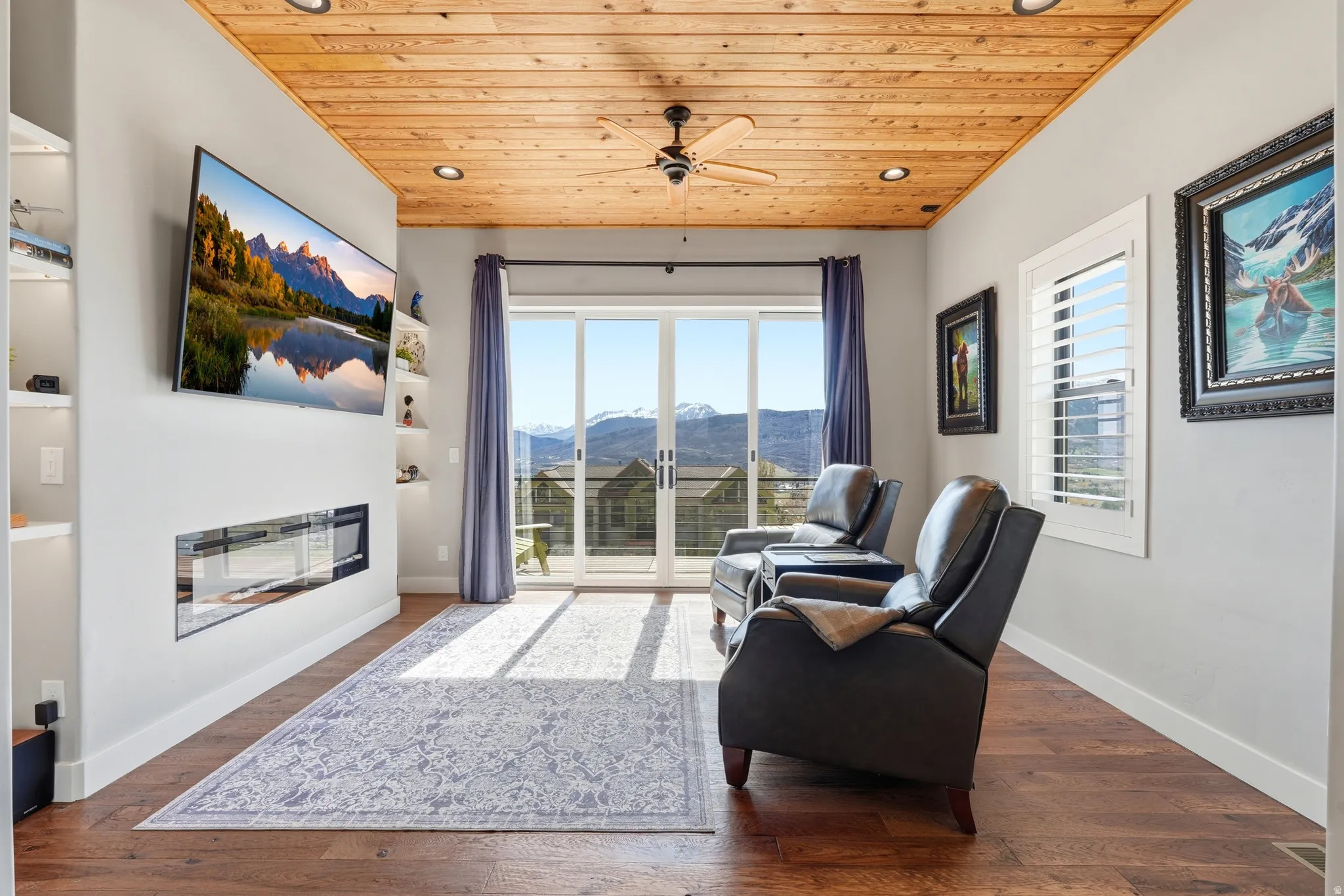 Living area featuring ceiling fan, wooden ceiling, dark wood finished floors, recessed lighting, and a glass covered fireplace
