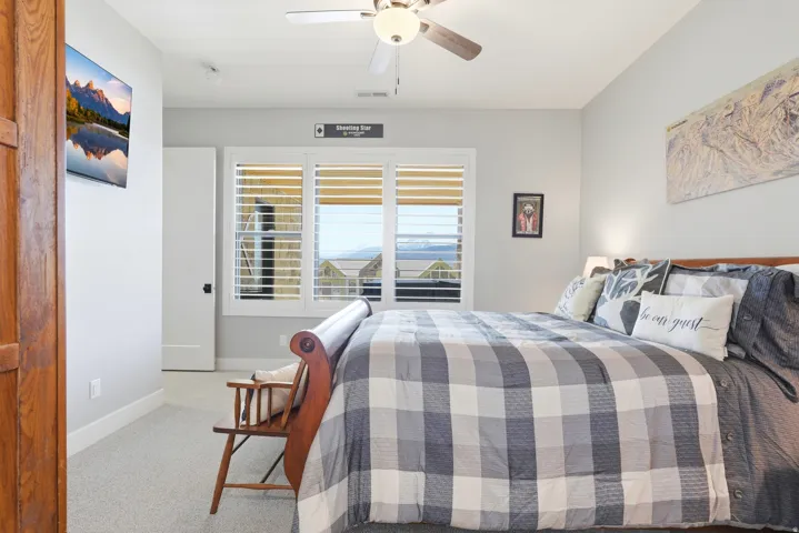 Bedroom featuring light carpet and a ceiling fan