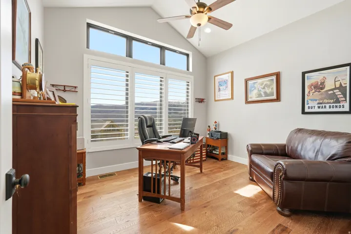 Home office featuring light wood-type flooring, vaulted ceiling, ceiling fan, and recessed lighting